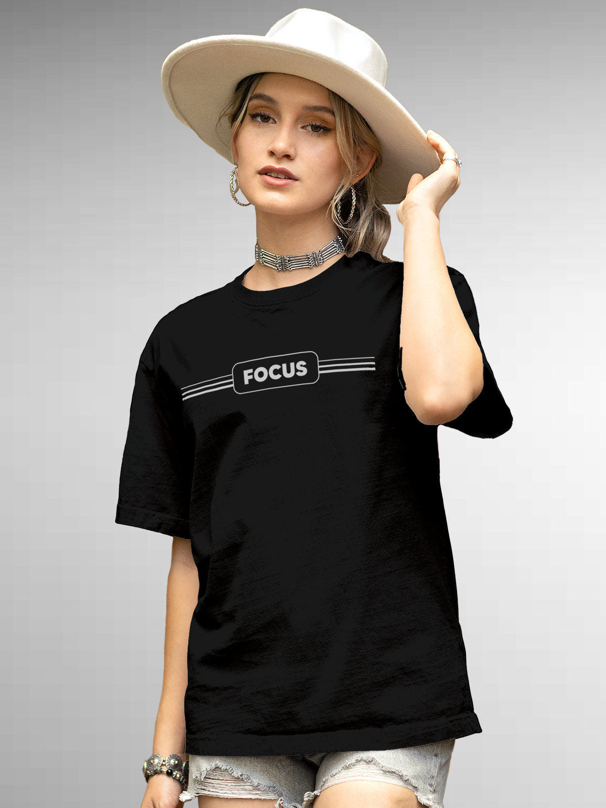 Model wearing Women's Black Round Neck T-shirt with 'Focus' design, offering effortless style and premium comfort