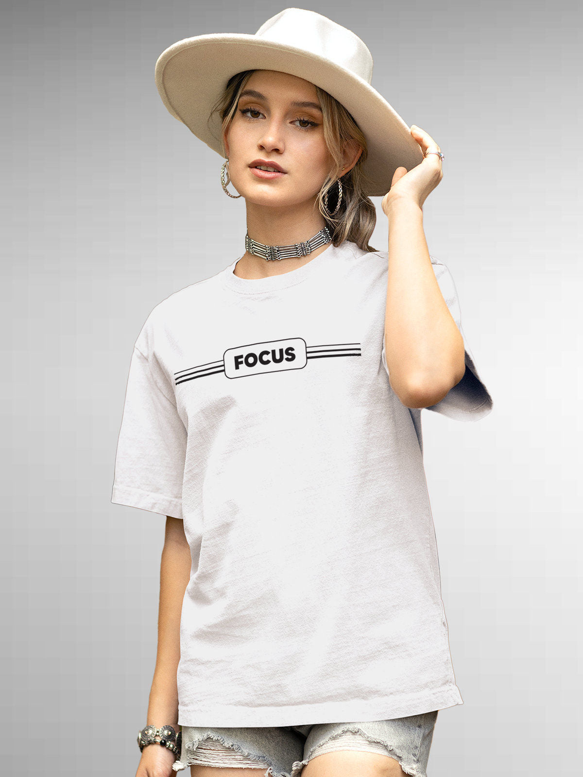 Model wearing Women's White Round Neck T-shirt with 'Focus' design, offering effortless style and premium comfort