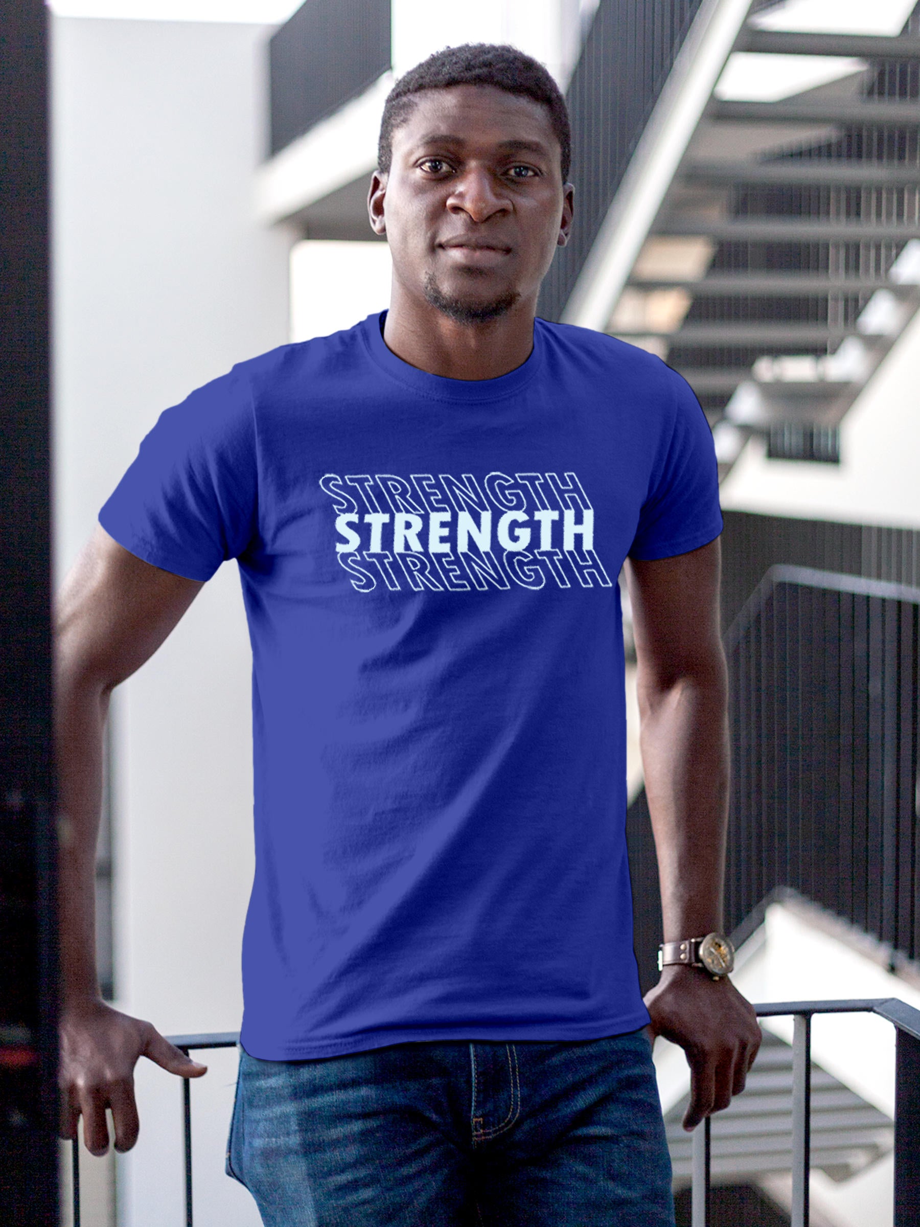 Model wearing Men's Blue Round Neck T-shirt with 'Strength' design, offering effortless style and premium comfort