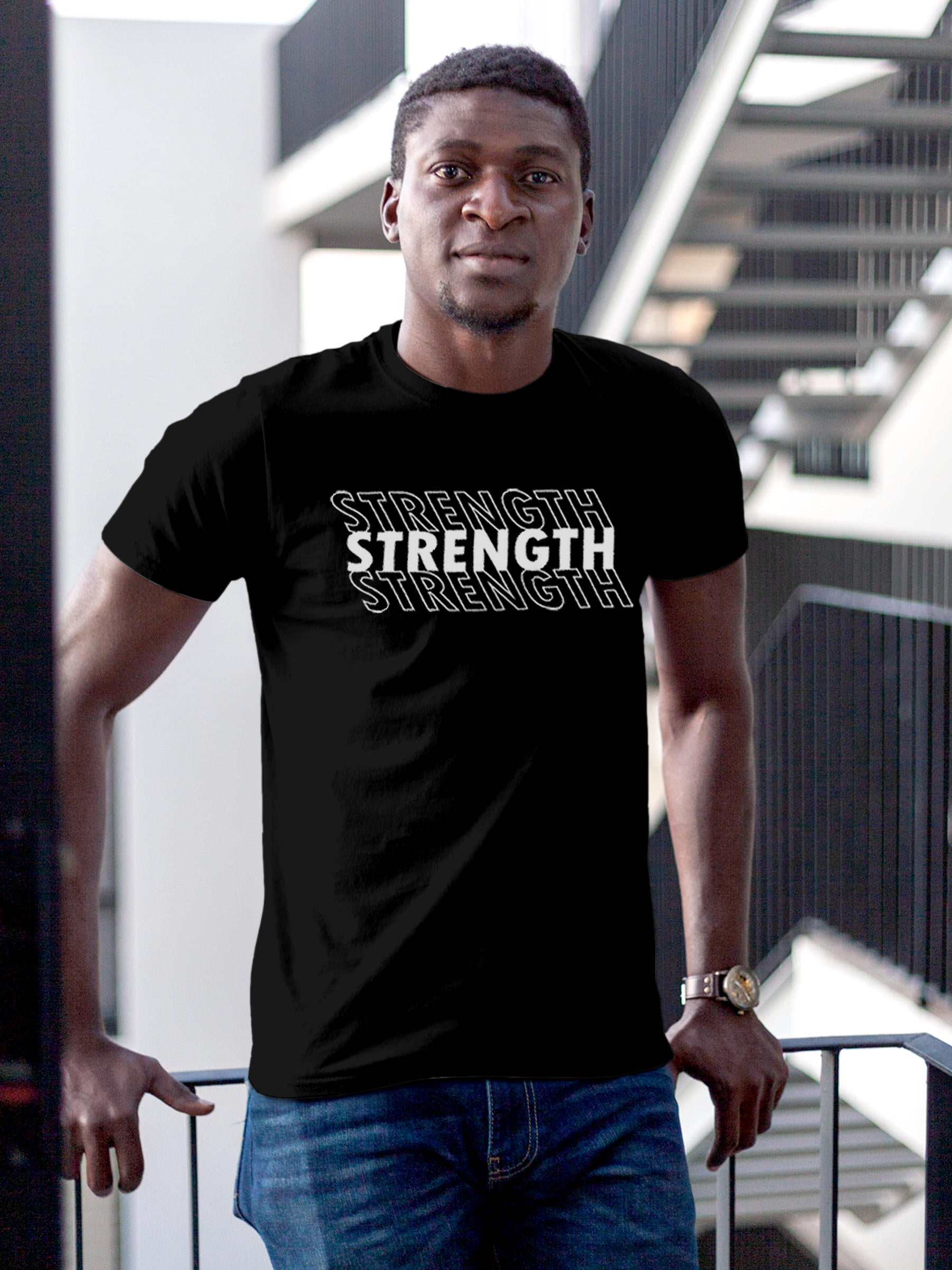 Model wearing Men's Black Round Neck T-shirt with 'Strength' design, offering effortless style and premium comfort