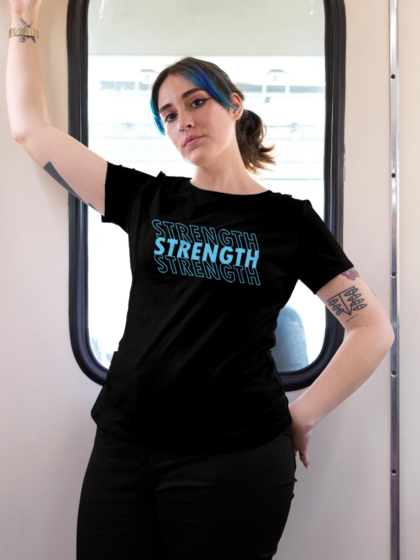 Model wearing Women's Black Round Neck T-shirt with 'Strength' design, offering effortless style and premium comfort