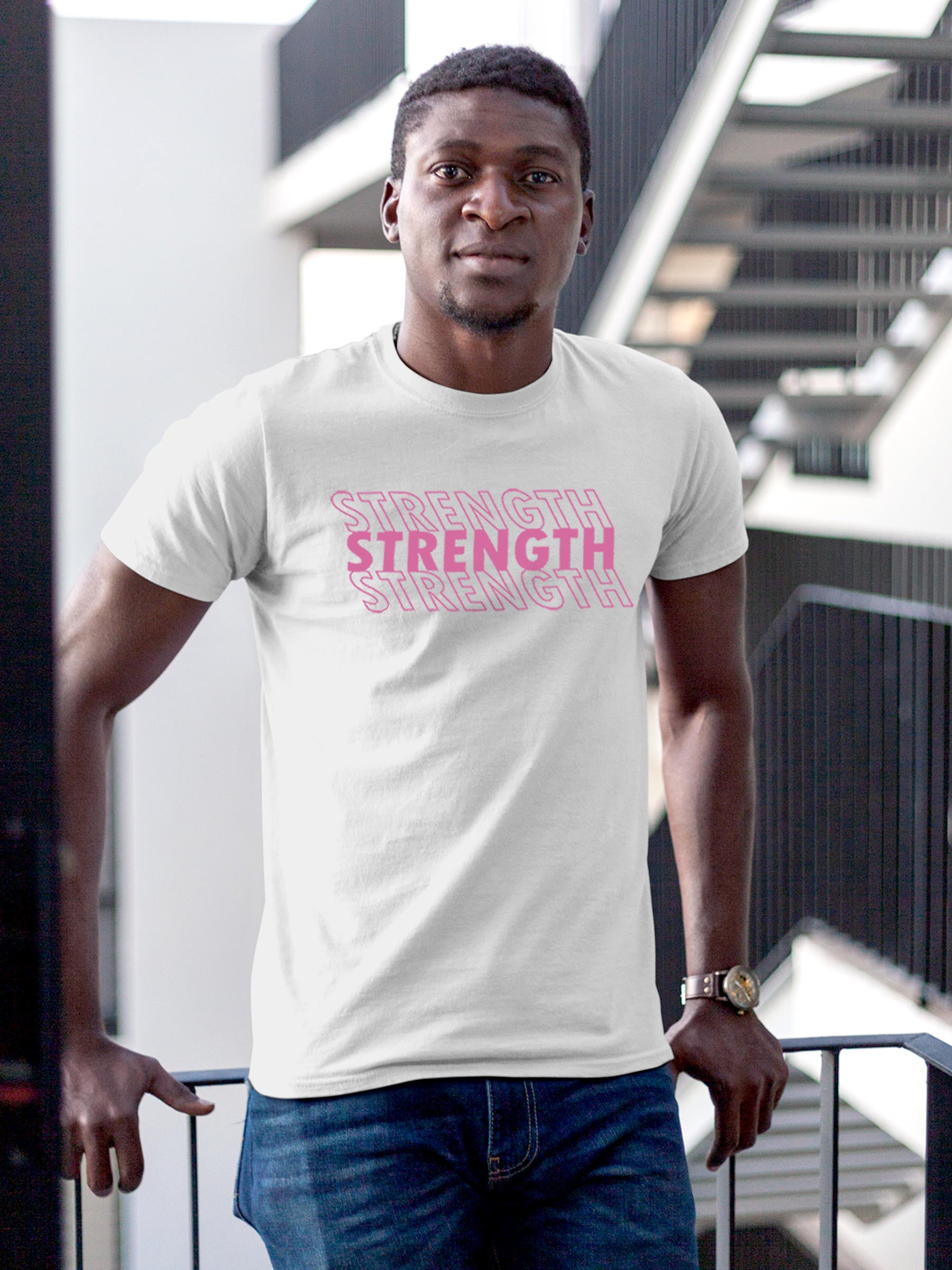 Model wearing Men's White Round Neck T-shirt with 'Strength' design, offering effortless style and premium comfort