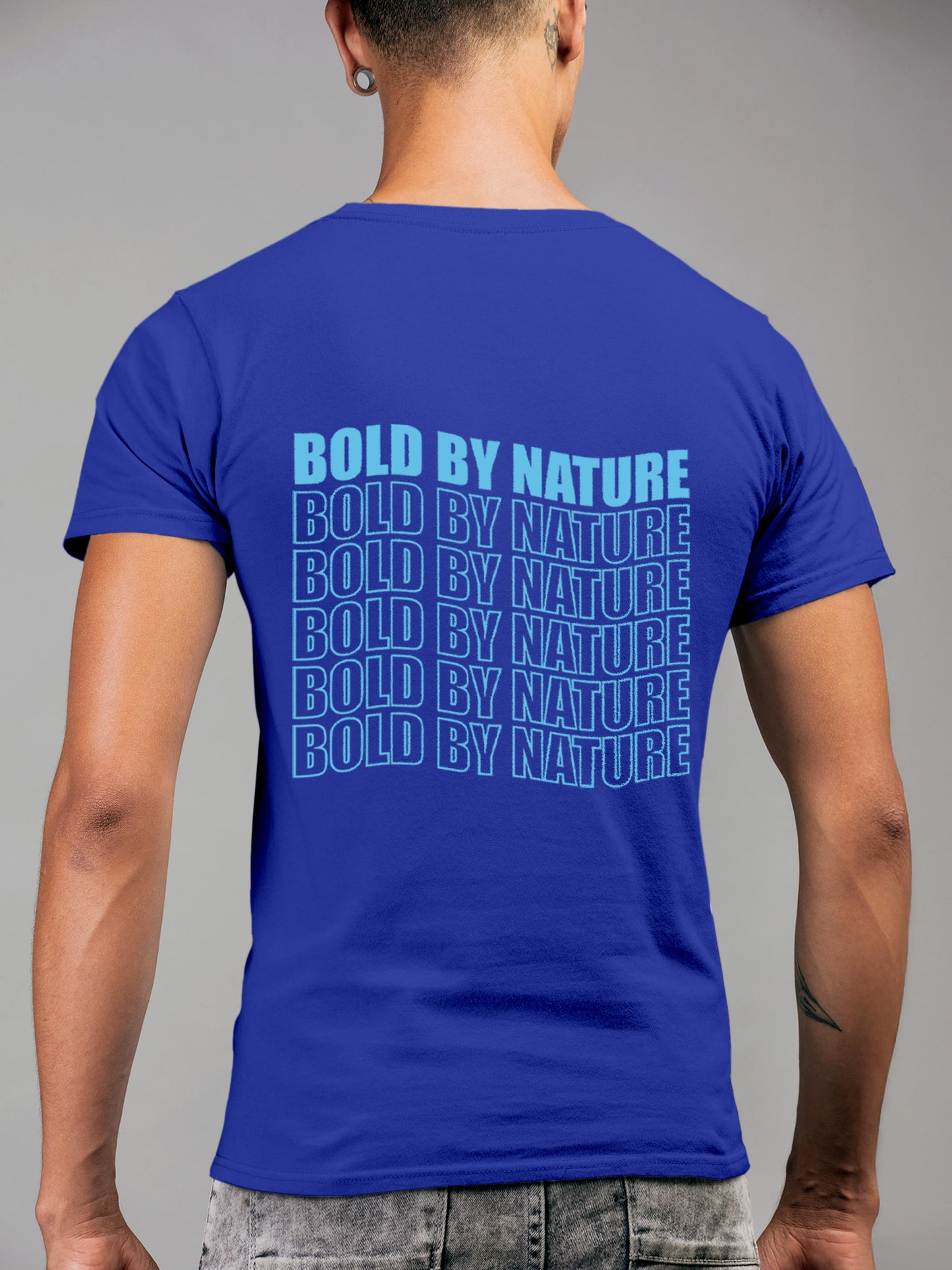 Model wearing Men's Blue Round Neck T-shirt with 'Bold By Nature' design, offering effortless style and premium comfort