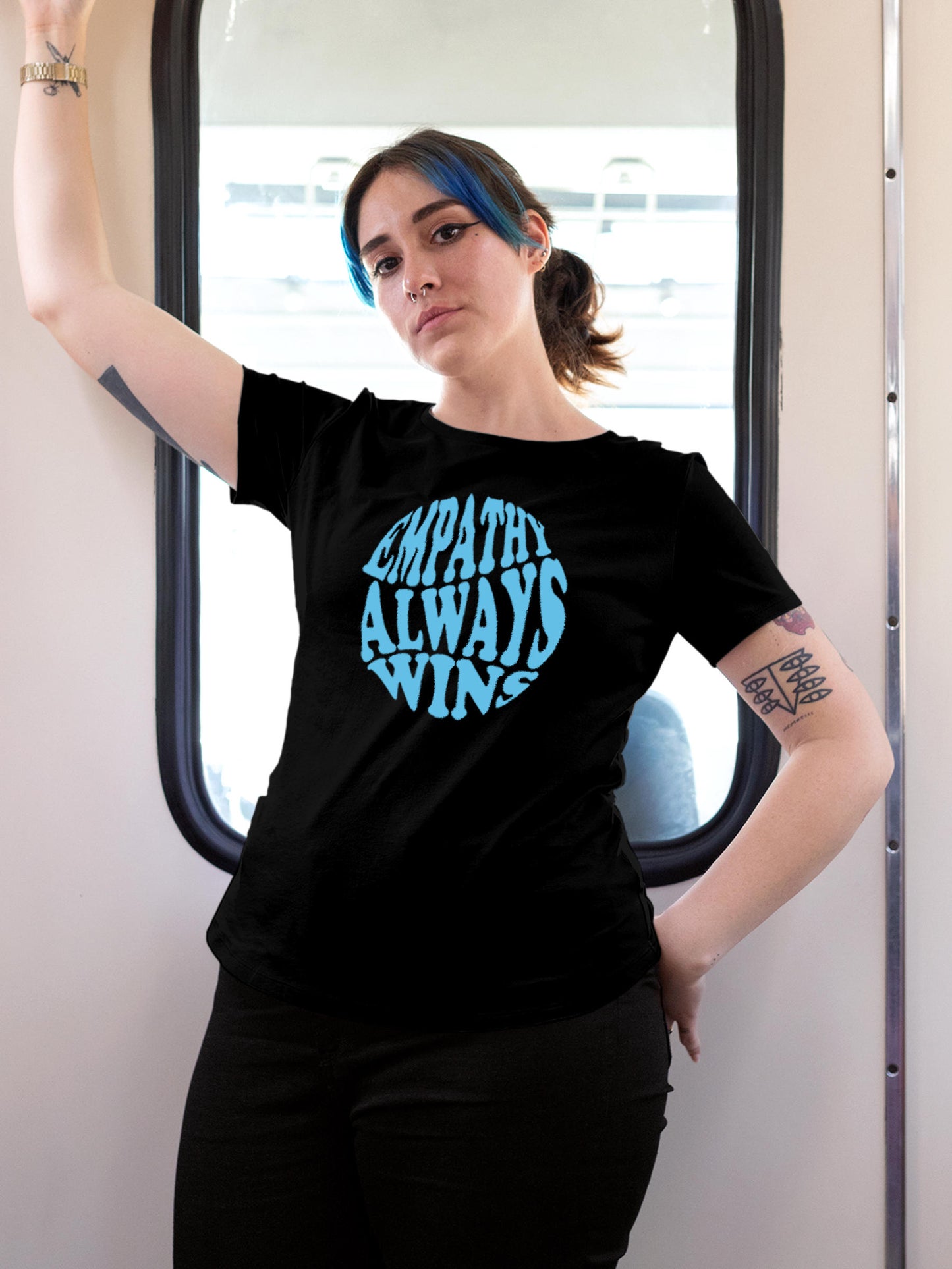 Model wearing Women's Black Round Neck T-shirt with 'Empathy Always Wins' design, offering effortless style and premium comfort