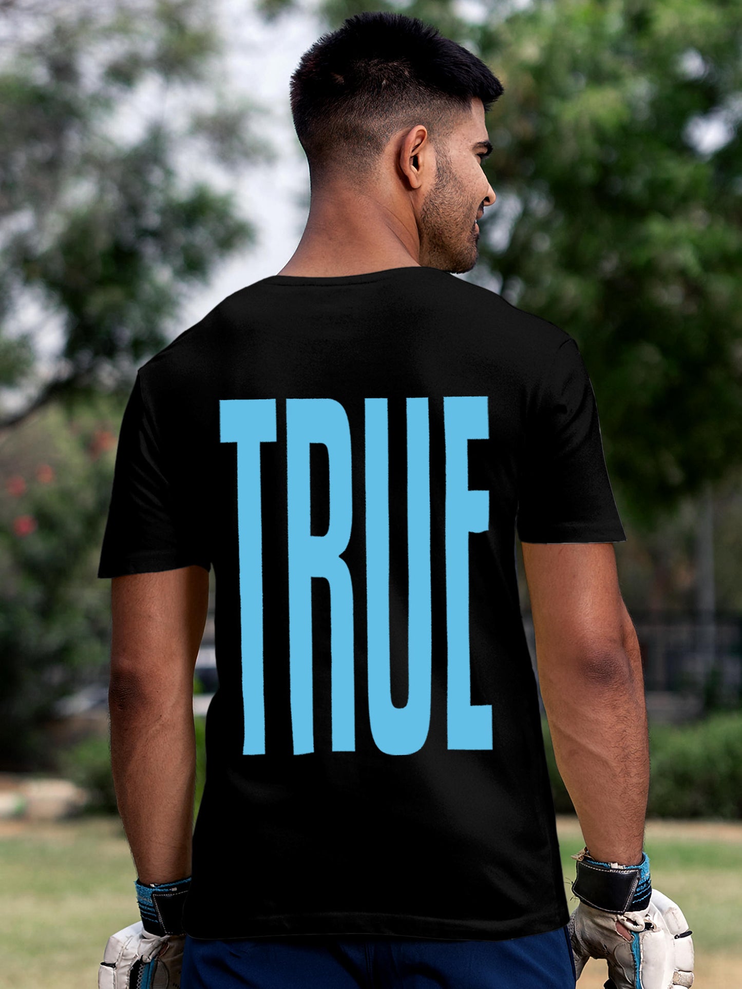 Model wearing Men's Black Round Neck T-shirt with 'Truth' design, offering effortless style and premium comfort