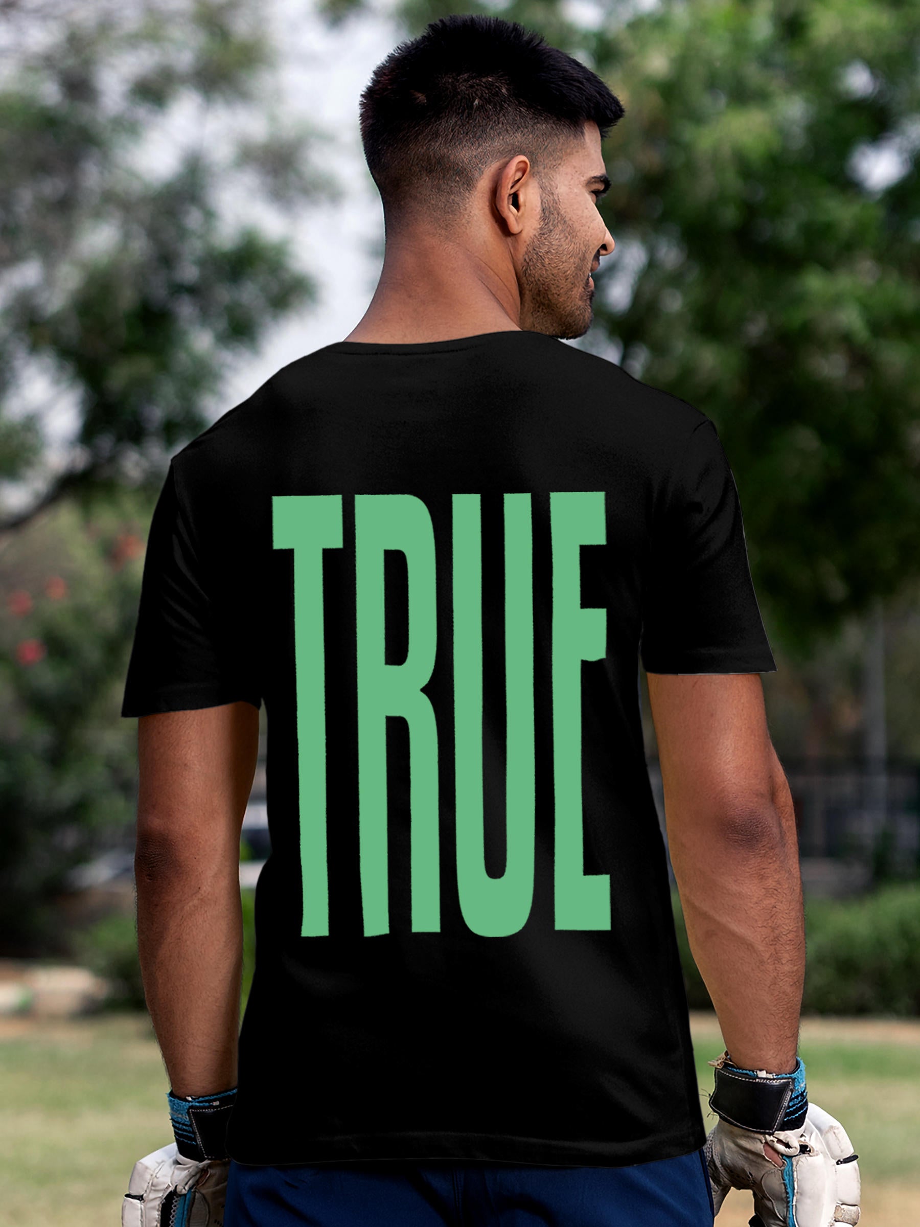 Model wearing Men's Black Round Neck T-shirt with 'Truth' design, offering effortless style and premium comfort
