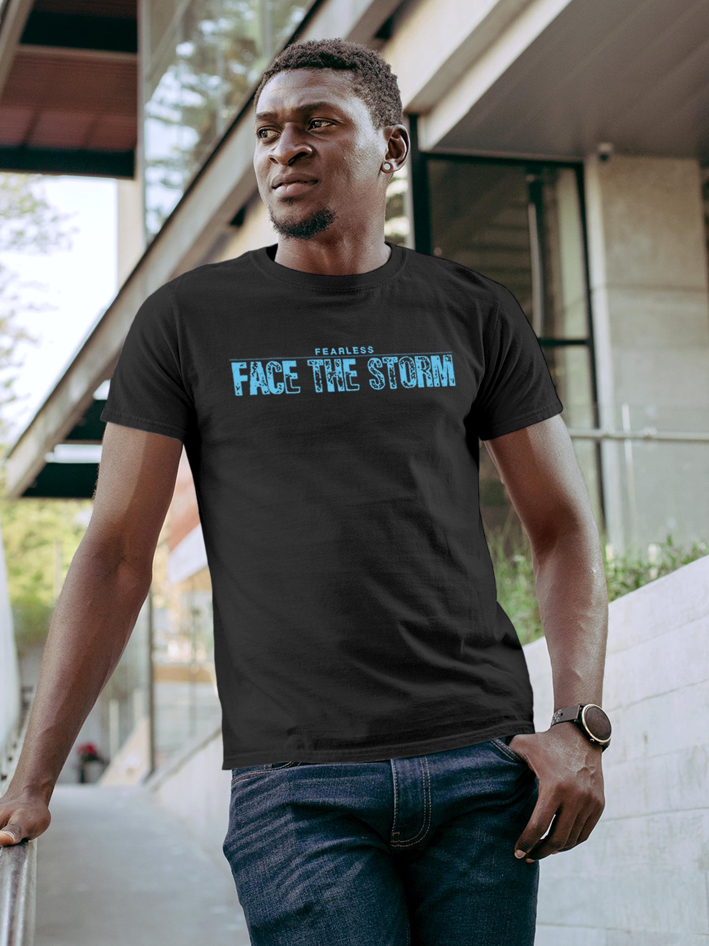 Model wearing Men's Dark Grey Round Neck T-shirt with 'Fearless. Face the Storm' design, offering effortless style and premium comfort
