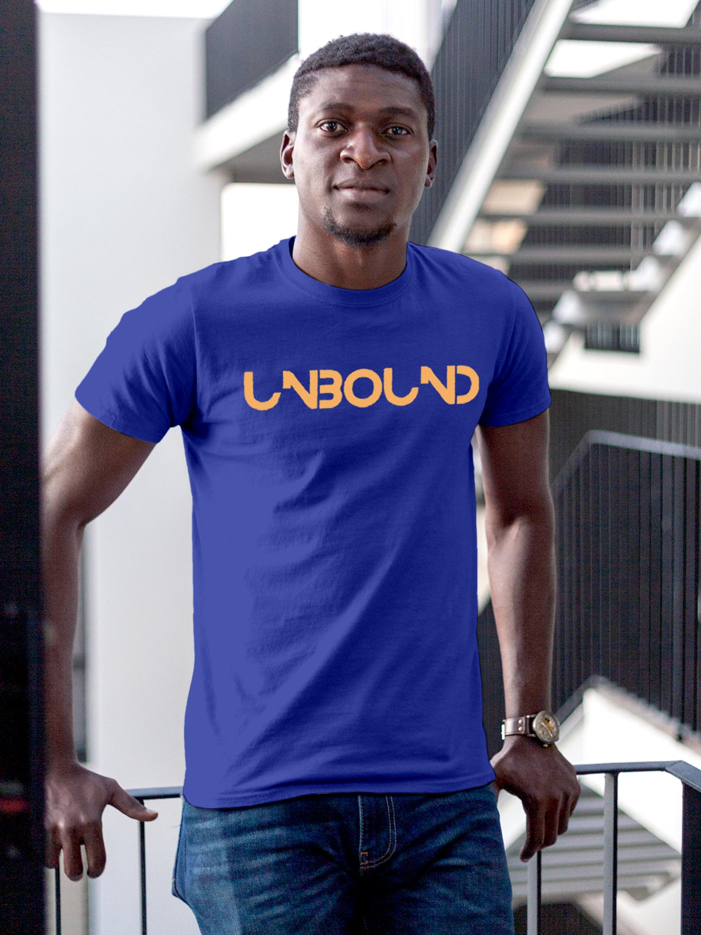 Model wearing Men's Blue Round Neck T-shirt with 'Unbound' design, offering effortless style and premium comfort