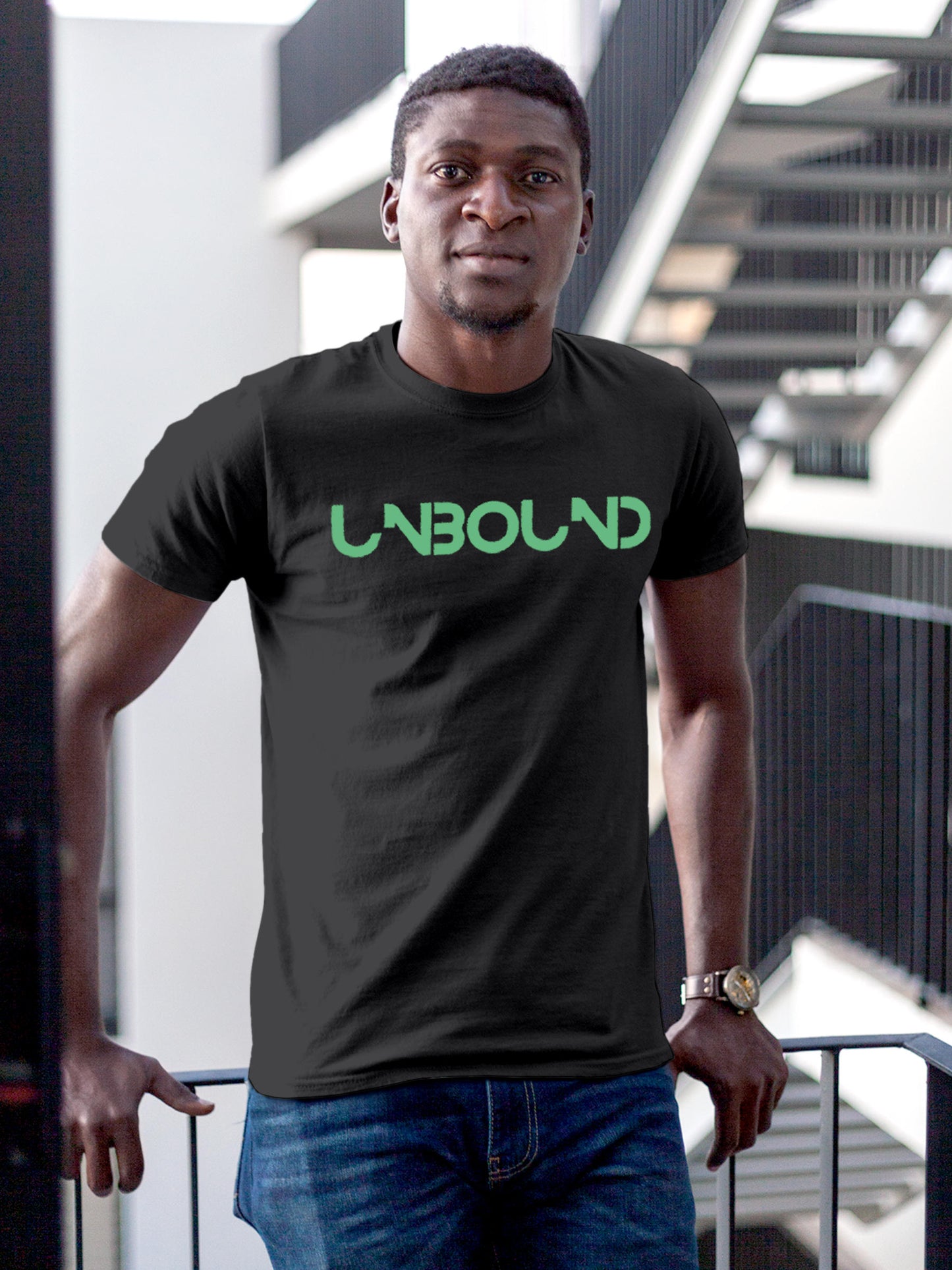 Model wearing Men's Dark Grey Round Neck T-shirt with 'Unbound' design, offering effortless style and premium comfort