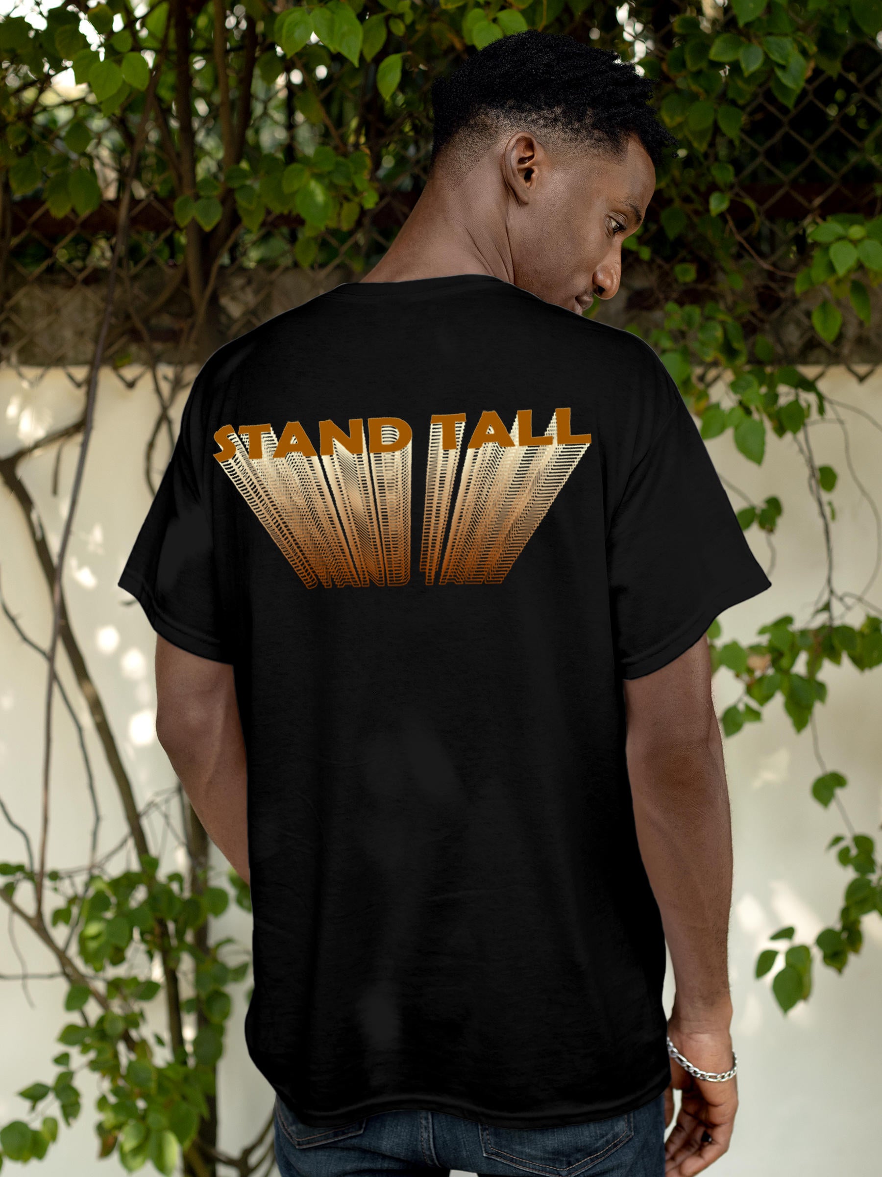 Model wearing Men's Black Round Neck T-shirt with 'Stand Tall' design, offering effortless style and premium comfort