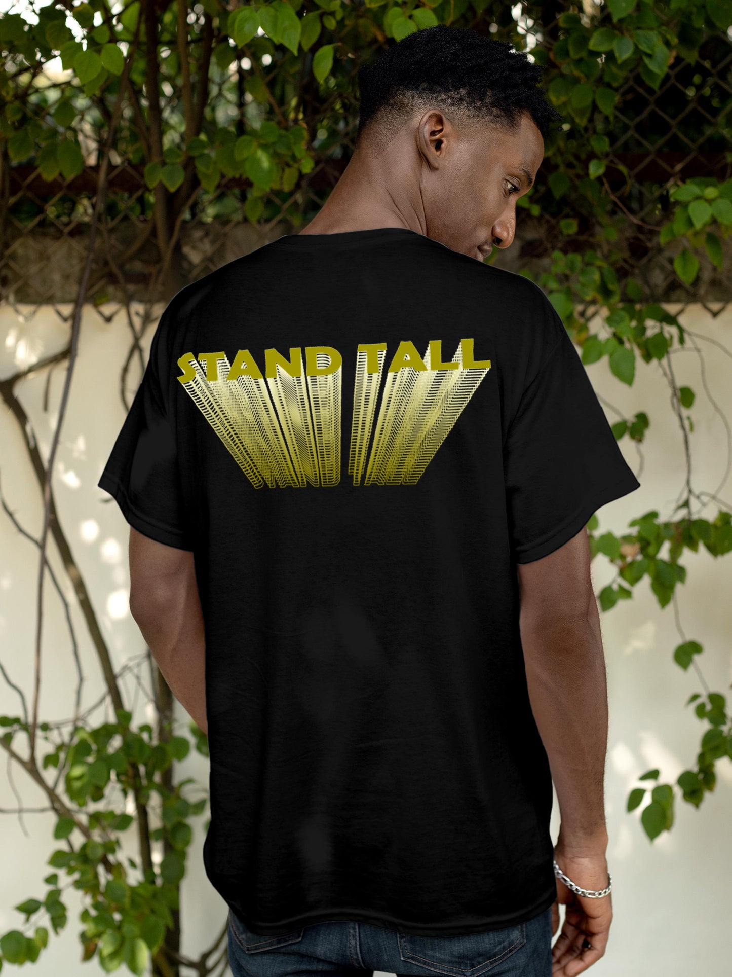Model wearing Men's Black Round Neck T-shirt with 'Stand Tall' design, offering effortless style and premium comfort