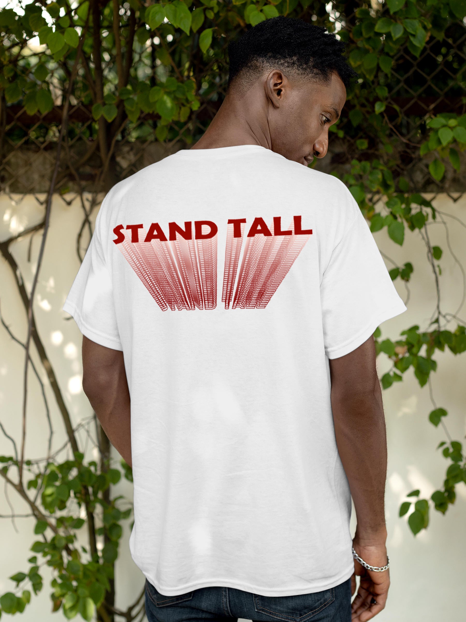 Model wearing Men's White Round Neck T-shirt with 'Stand Tall' design, offering effortless style and premium comfort