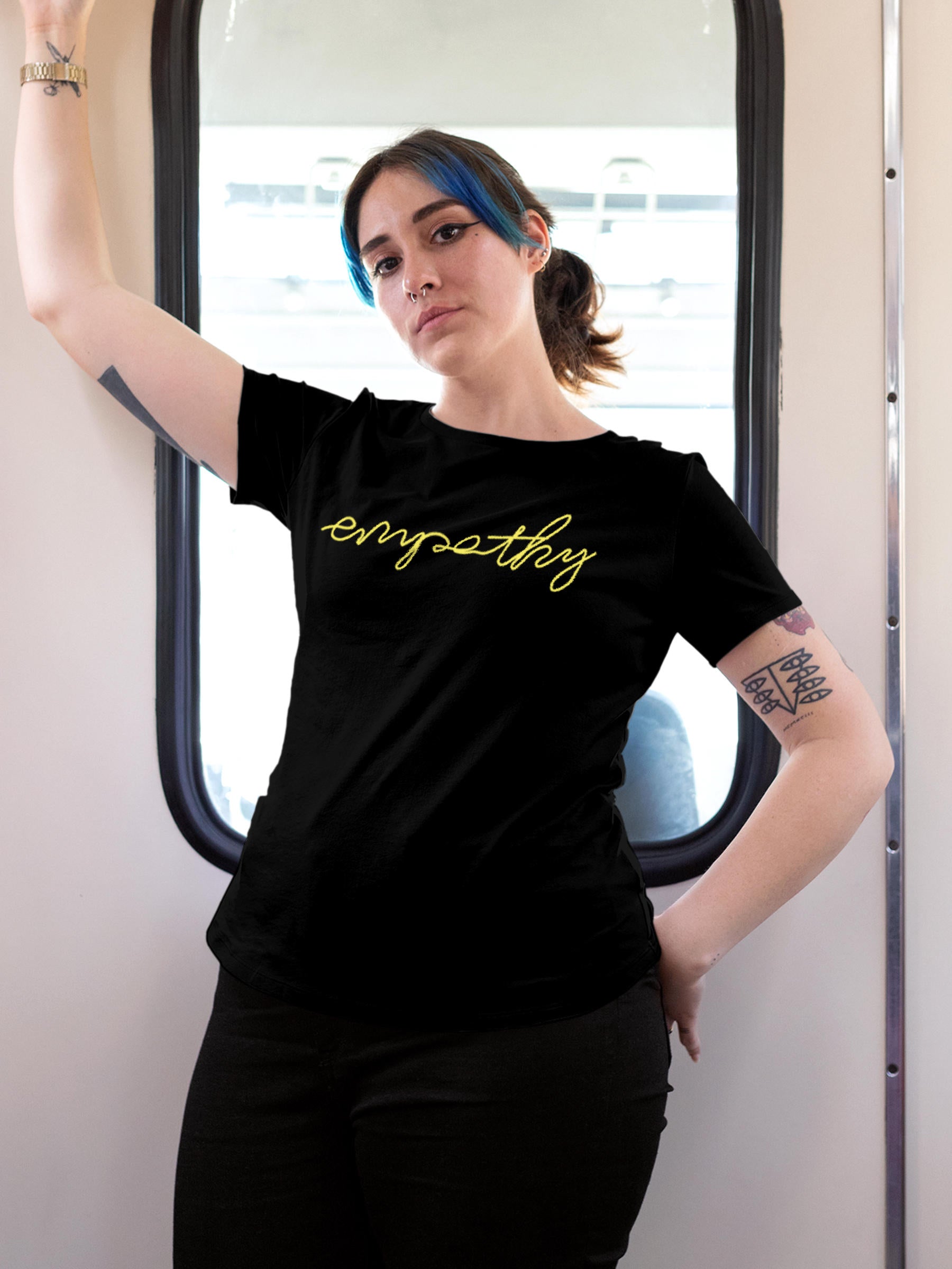 Model wearing Women's Black Round Neck T-shirt with 'Empathy' design, offering effortless style and premium comfort