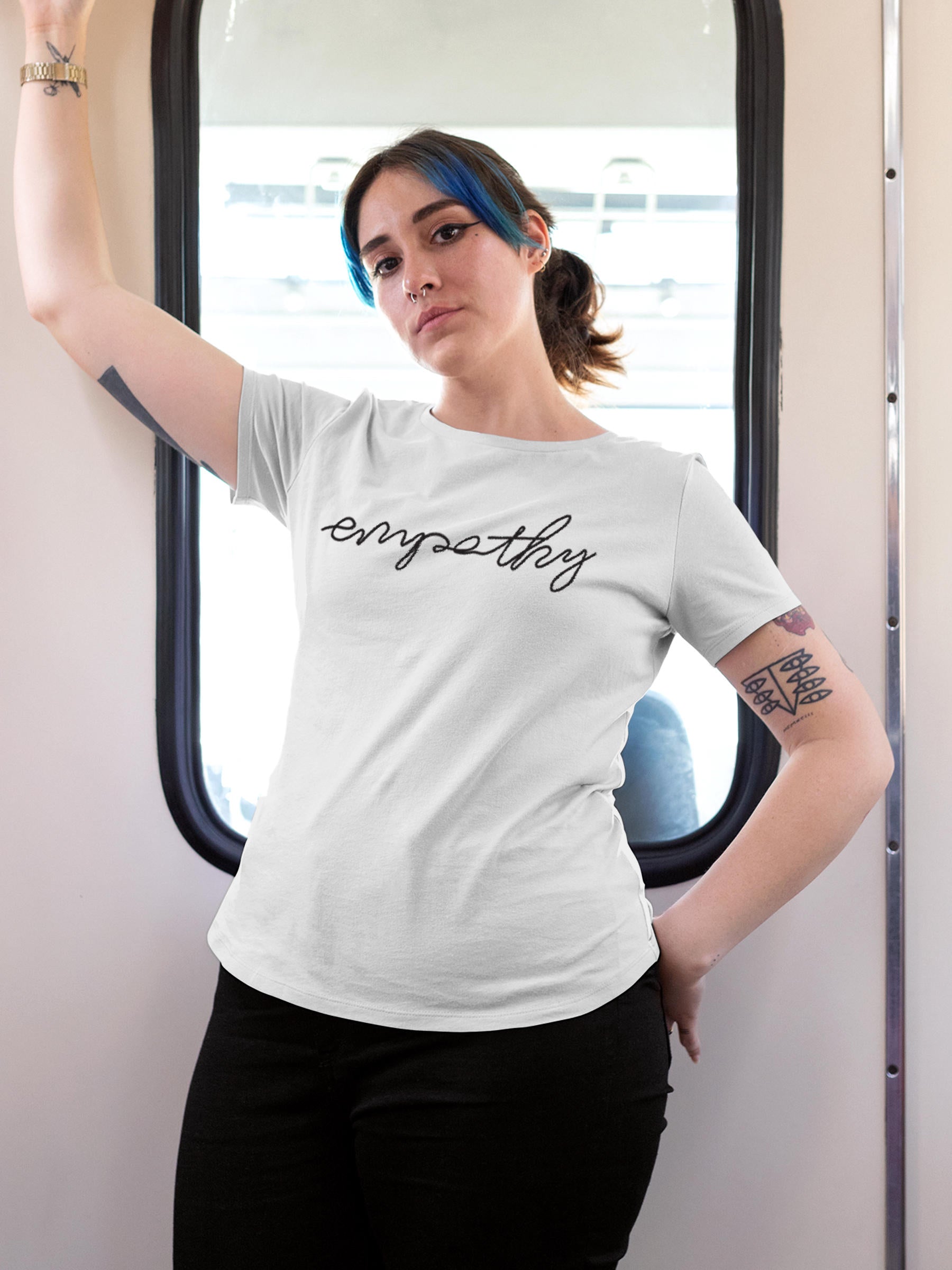 Model wearing Women's White Round Neck T-shirt with 'Empathy' design, offering effortless style and premium comfort