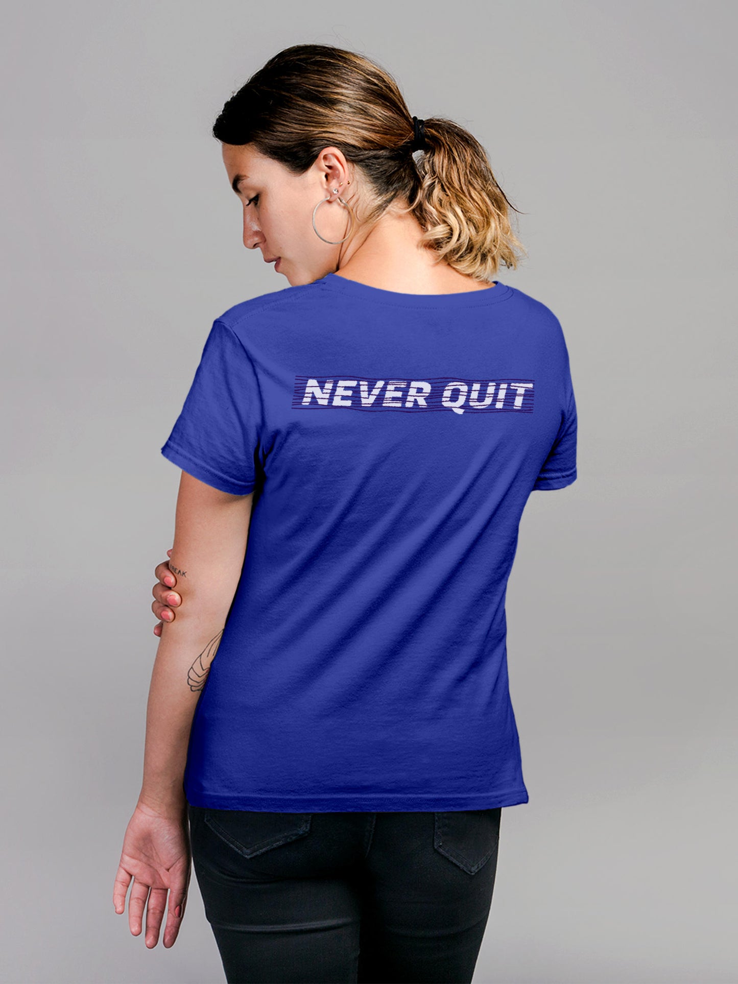 Model wearing Women's Blue Round Neck T-shirt with 'Never Quit' design, offering effortless style and premium comfort