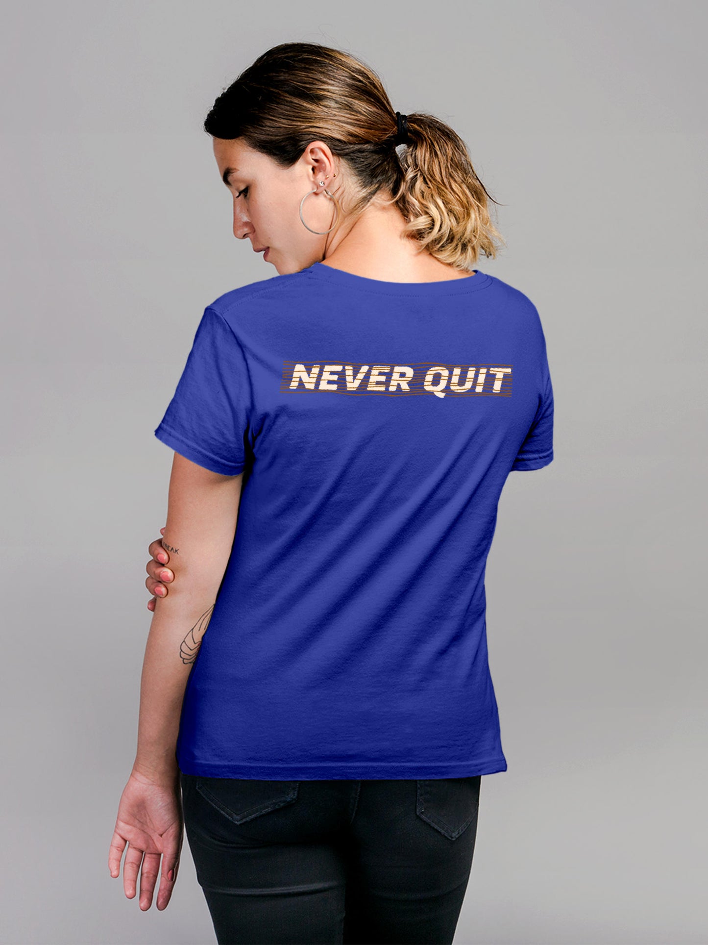 Model wearing Women's Blue Round Neck T-shirt with 'Never Quit' design, offering effortless style and premium comfort
