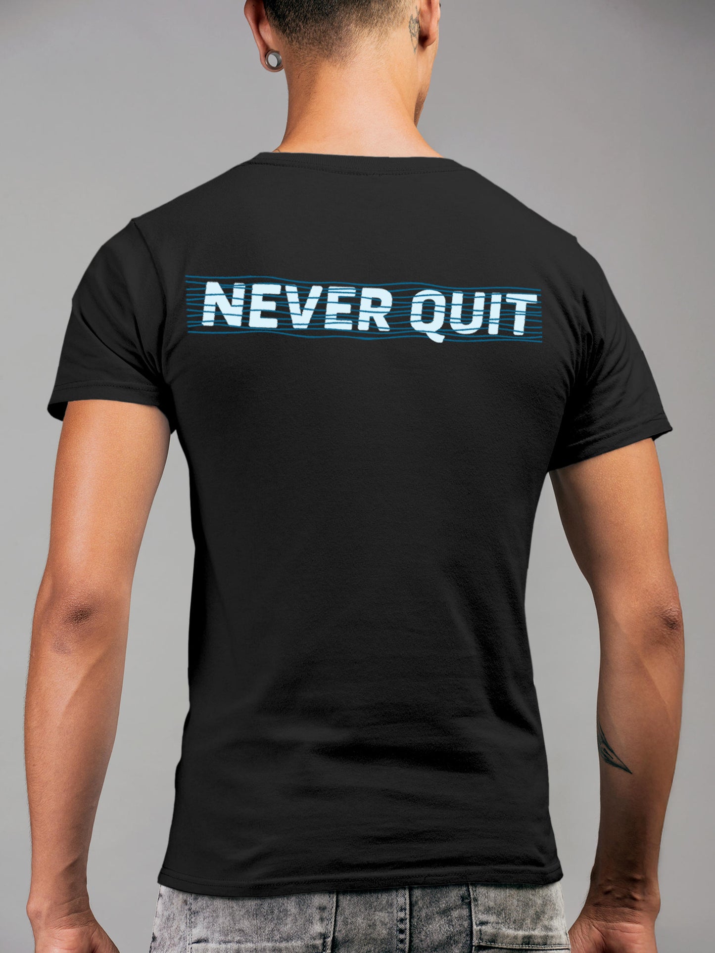 Model wearing Men's Dark Grey Round Neck T-shirt with 'Never Quit' design, offering effortless style and premium comfort