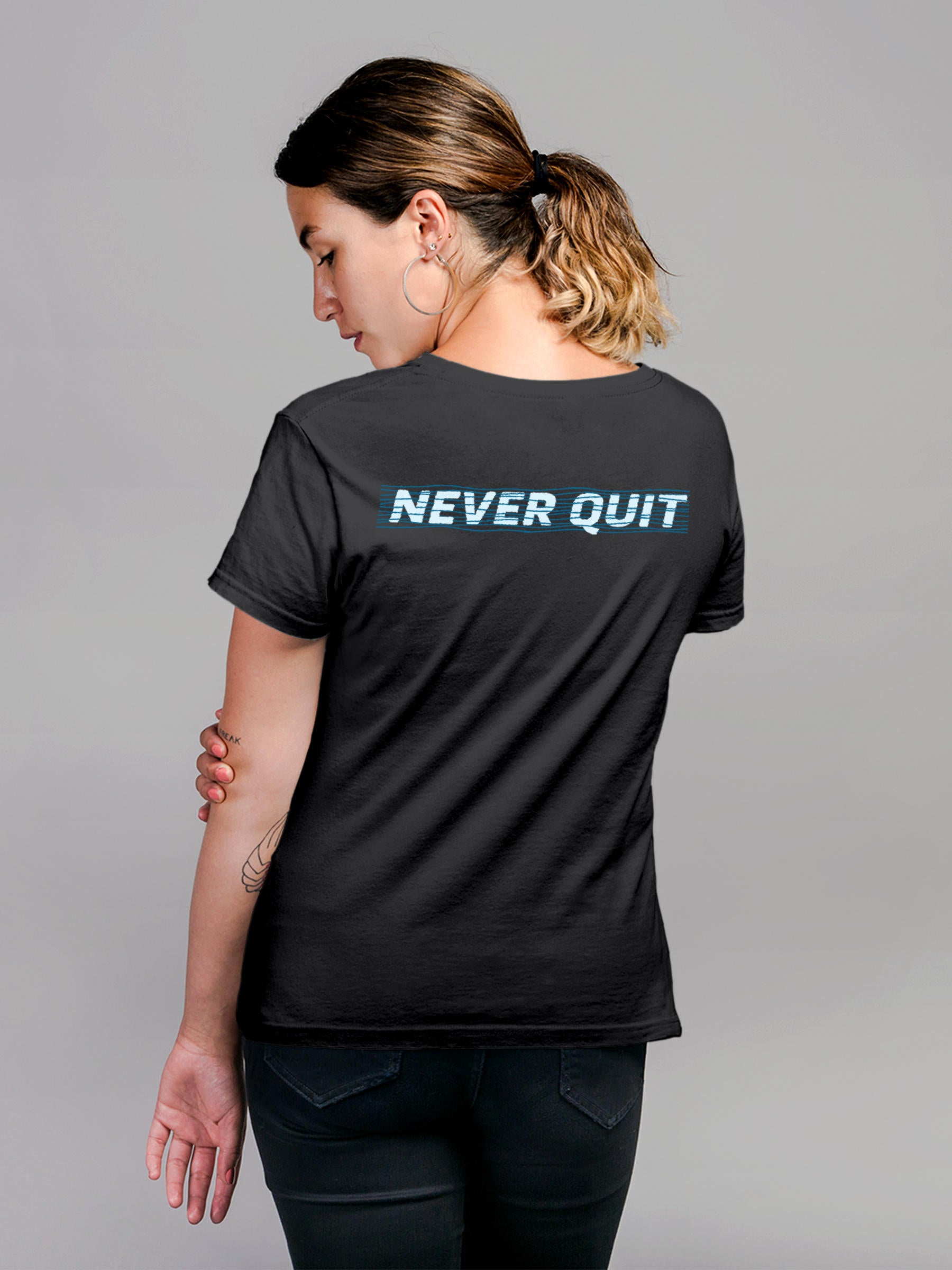 Model wearing Women's Dark Grey Round Neck T-shirt with 'Never Quit' design, offering effortless style and premium comfort