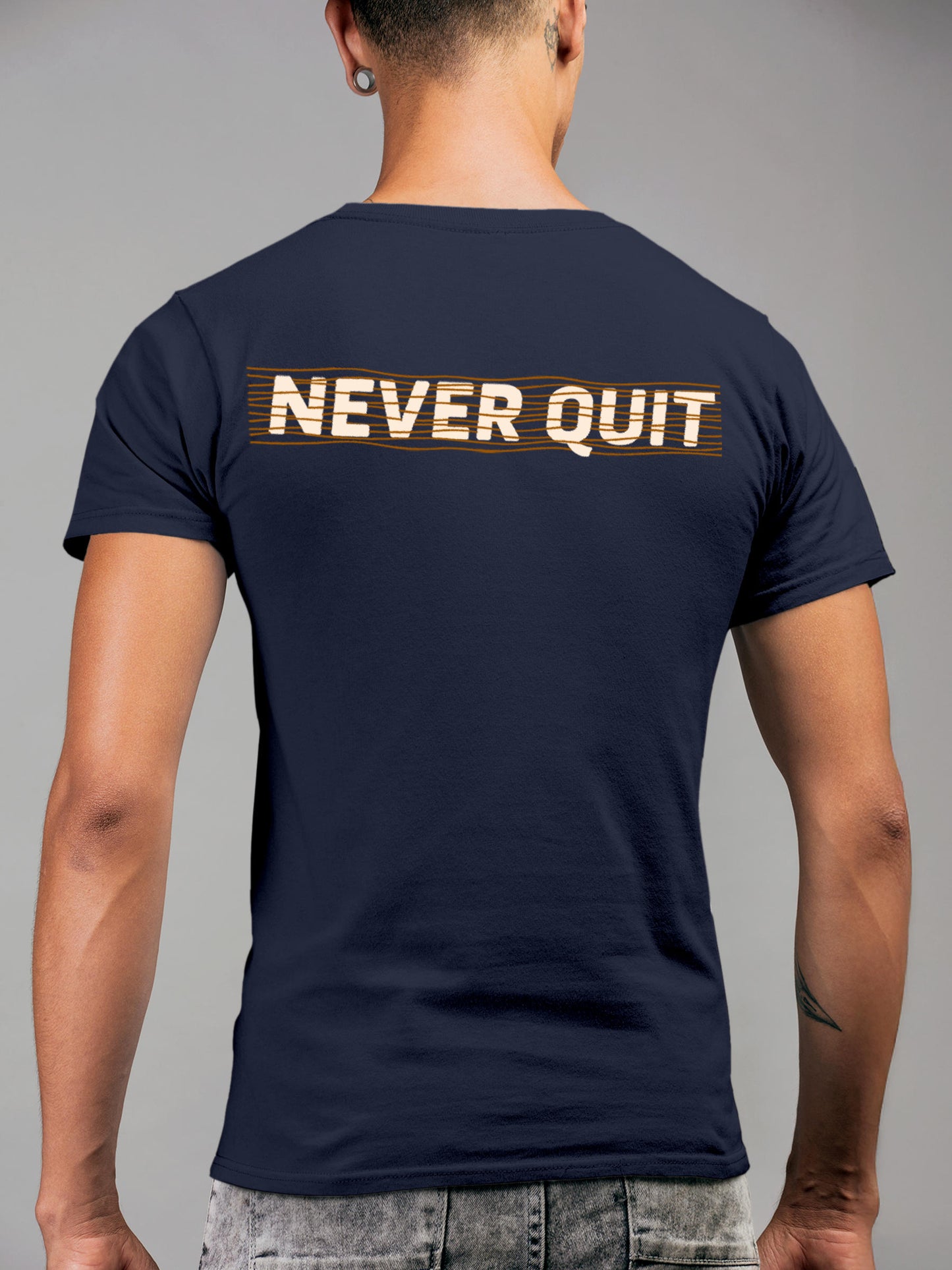 Model wearing Men's Navy Blue Round Neck T-shirt with 'Never Quit' design, offering effortless style and premium comfort