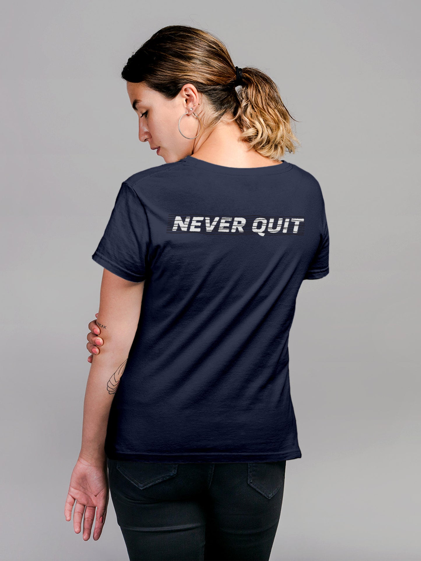 Model wearing Women's Navy Blue Round Neck T-shirt with 'Never Quit' design, offering effortless style and premium comfort