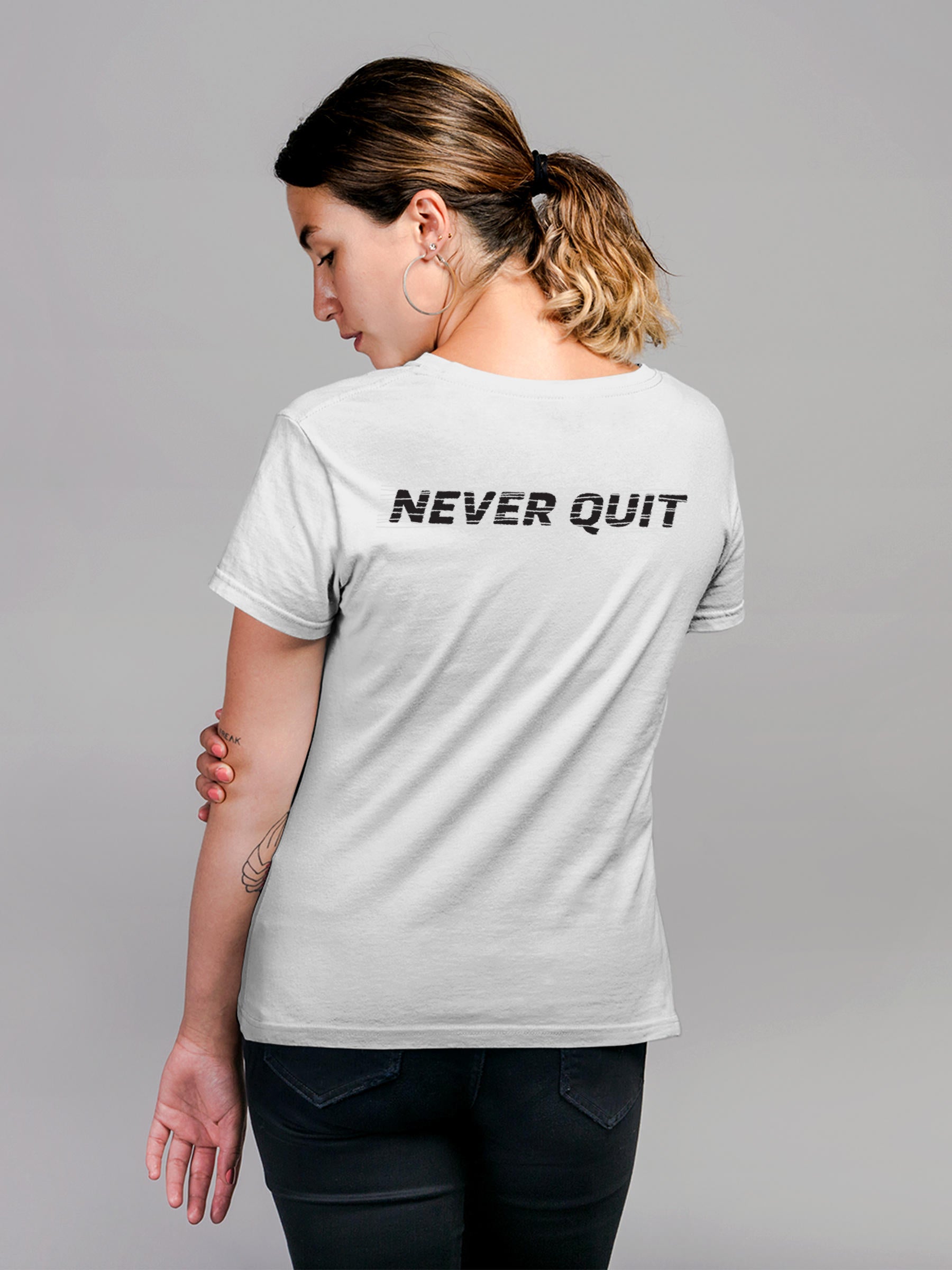 Model wearing Women's White Round Neck T-shirt with 'Never Quit' design, offering effortless style and premium comfort