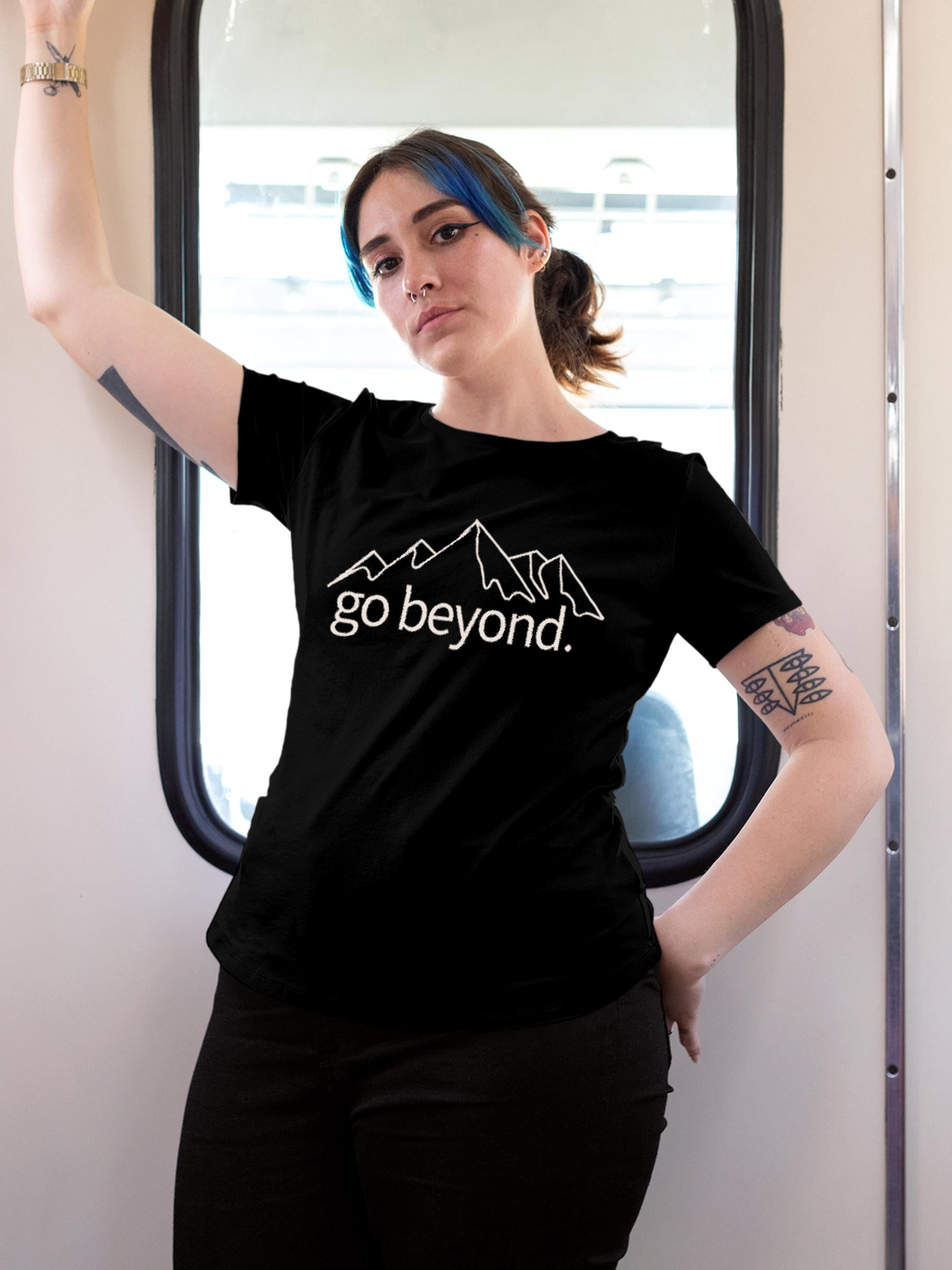 Model wearing Women's Black Round Neck T-shirt with 'Go Beyond' design, offering effortless style and premium comfort