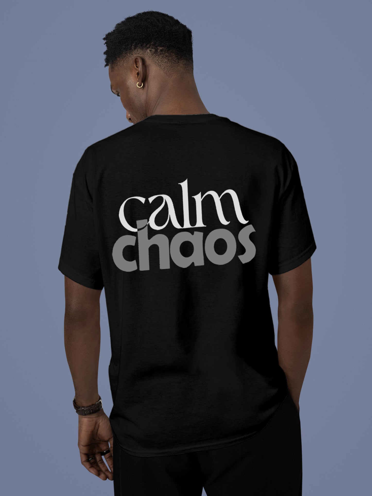 Model wearing Men's Black Round Neck T-shirt with 'Calm Chaos' design, offering effortless style and premium comfort