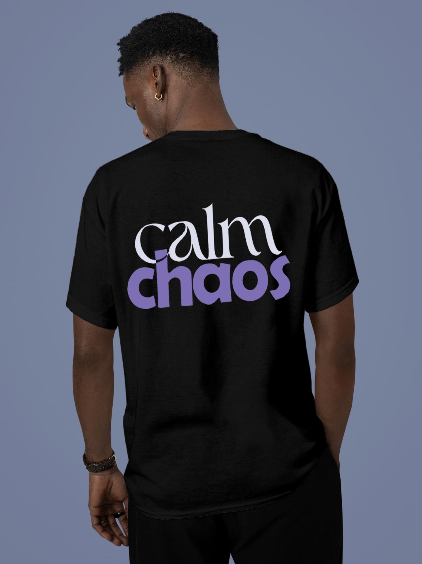 Model wearing Men's Black Round Neck T-shirt with 'Calm Chaos' design, offering effortless style and premium comfort