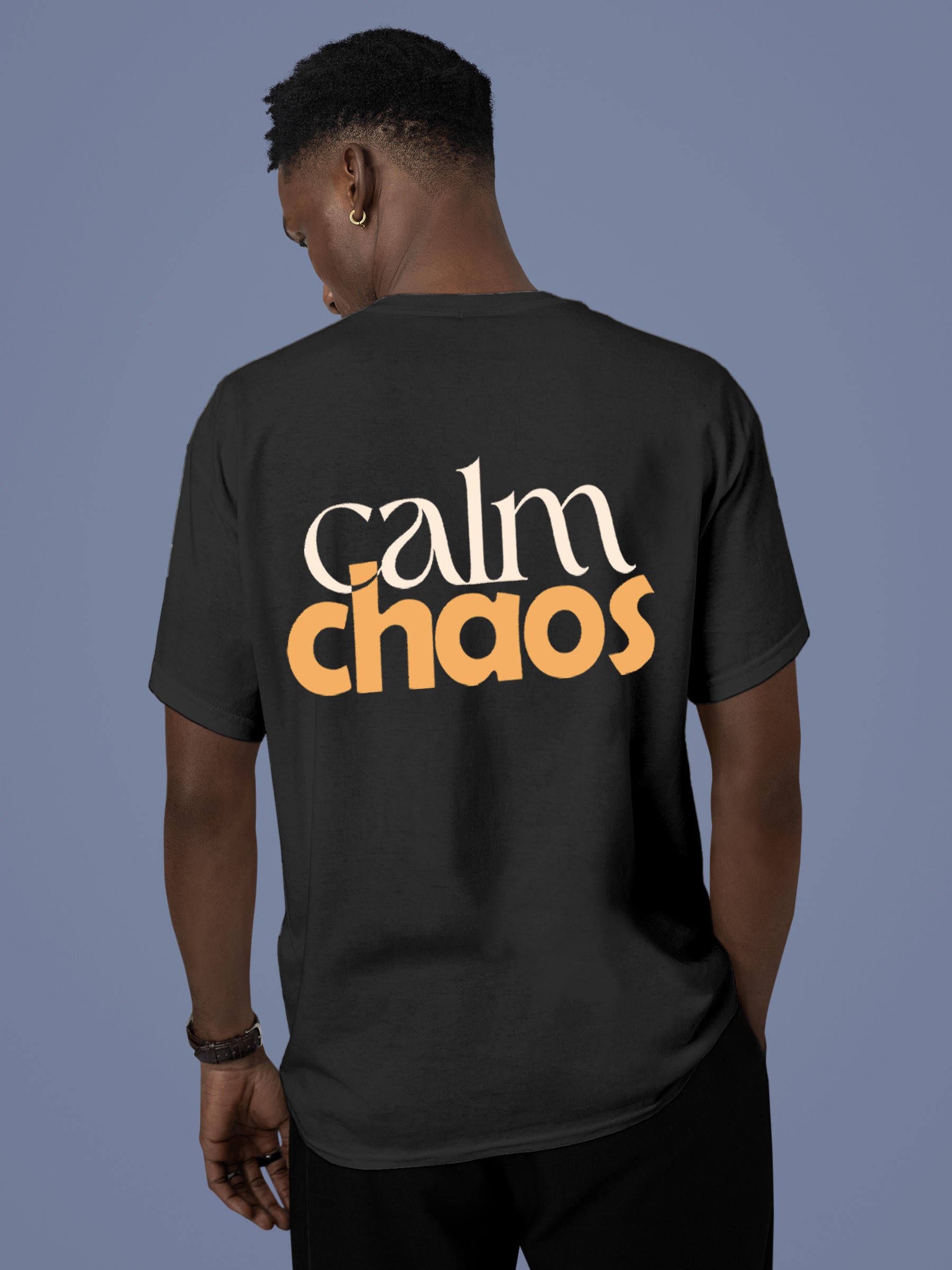 Model wearing Men's Dark Grey Round Neck T-shirt with 'Calm Chaos' design, offering effortless style and premium comfort