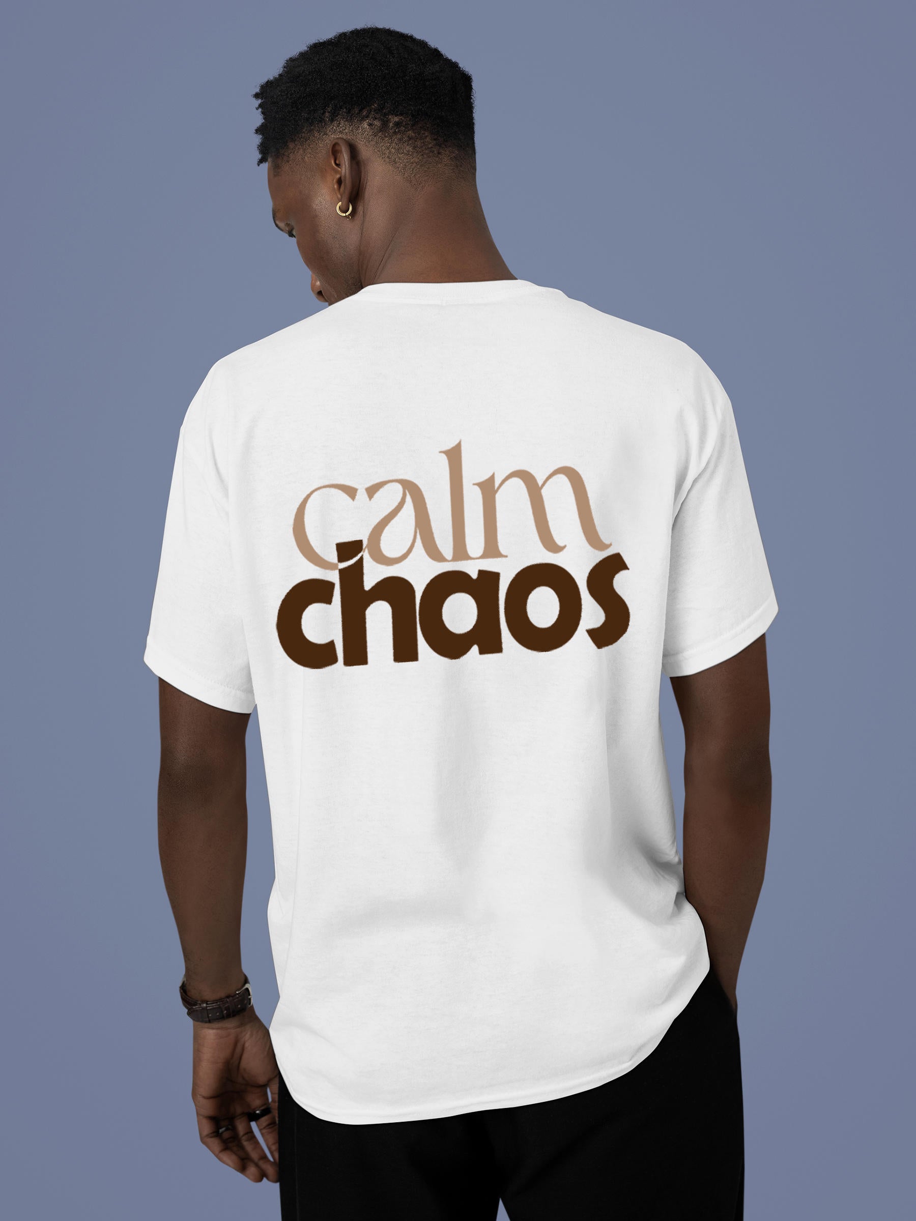 Model wearing Men's White Round Neck T-shirt with 'Calm Chaos' design, offering effortless style and premium comfort