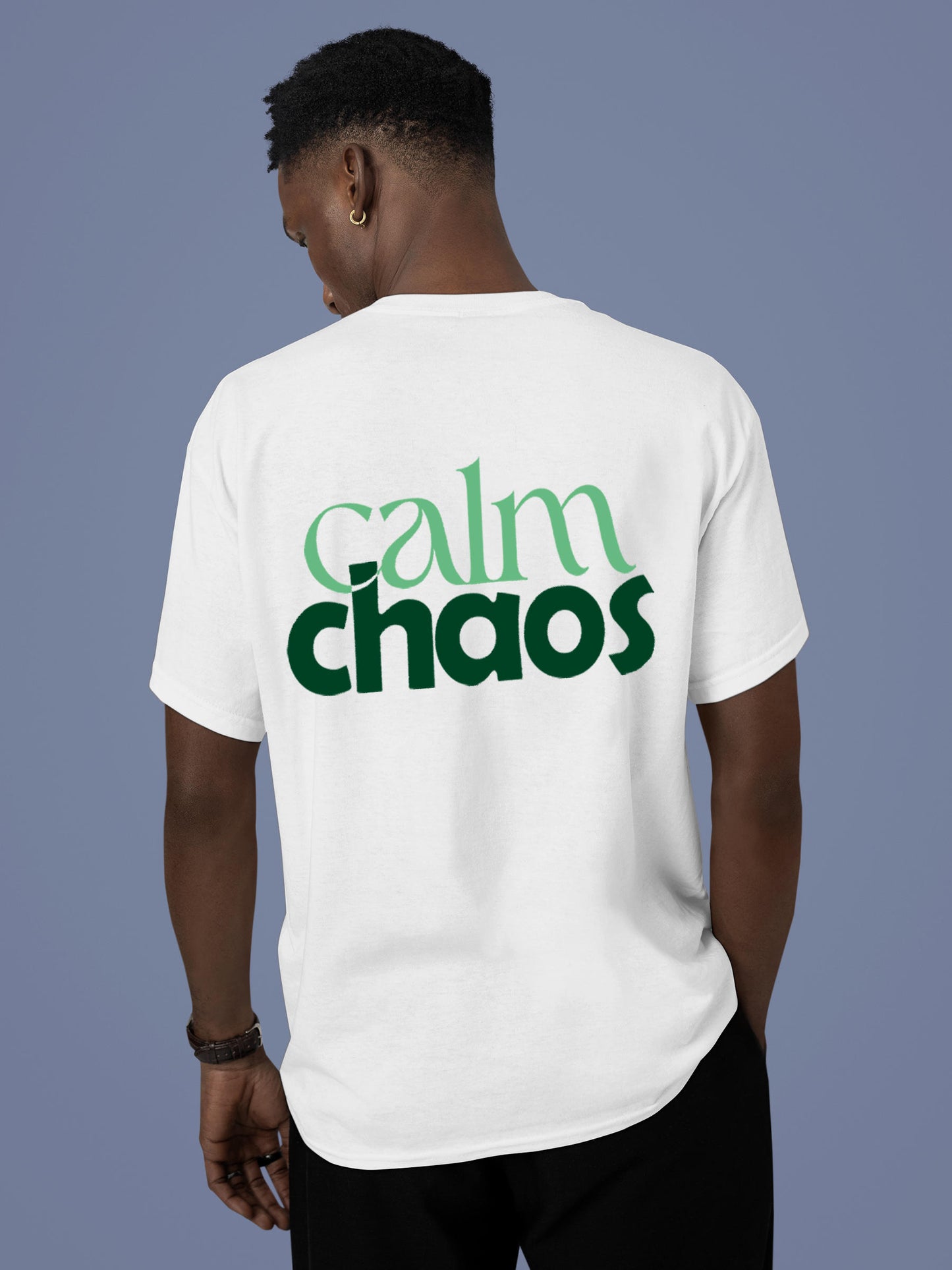 Model wearing Men's White Round Neck T-shirt with 'Calm Chaos' design, offering effortless style and premium comfort