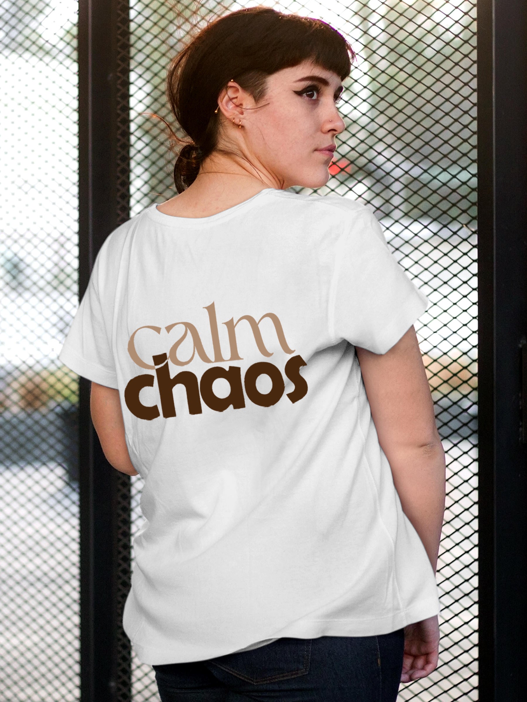 Model wearing Women's White Round Neck T-shirt with 'Calm Chaos' design, offering effortless style and premium comfort