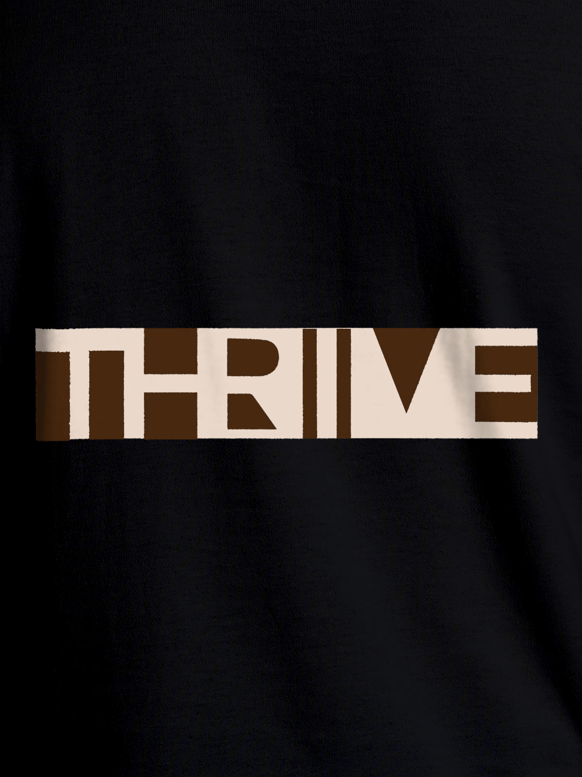 Close up of 'Thrive' design on Women's Black Round Neck T-shirt, highlighting intricate details and vibrant print.