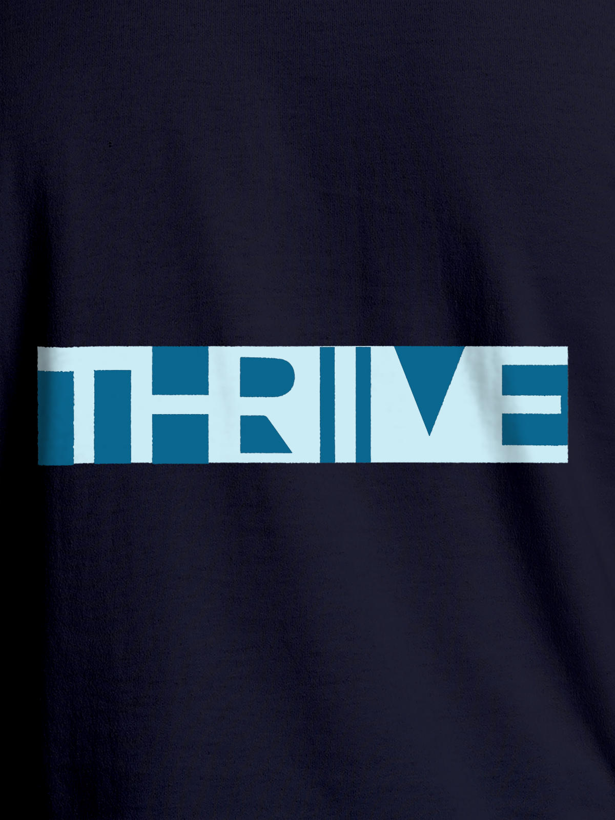 Close up of 'Thrive' design on Women's Navy Blue Round Neck T-shirt, highlighting intricate details and vibrant print.