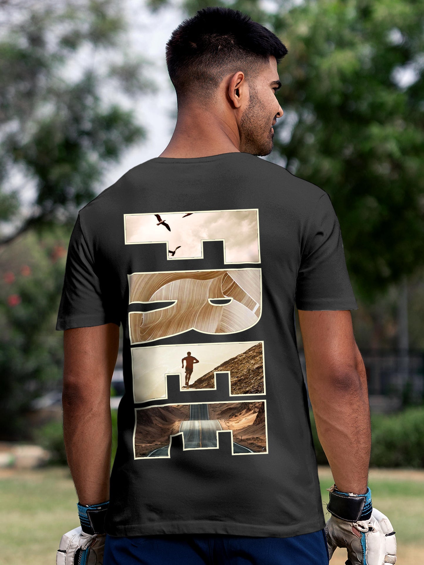 Model wearing Men's Dark Grey Round Neck T-shirt with 'Free & Boundless' design, offering effortless style and premium comfort