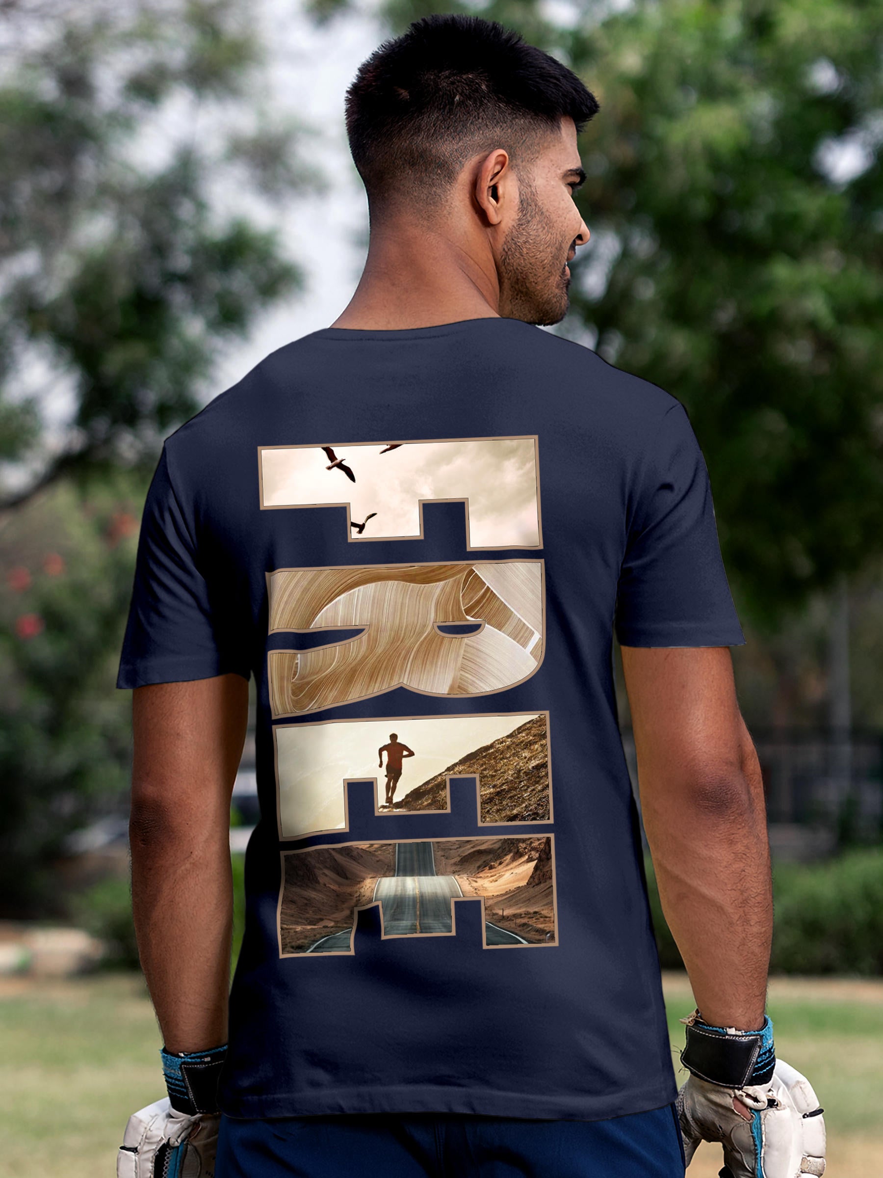 Model wearing Men's Navy Blue Round Neck T-shirt with 'Free & Boundless' design, offering effortless style and premium comfort