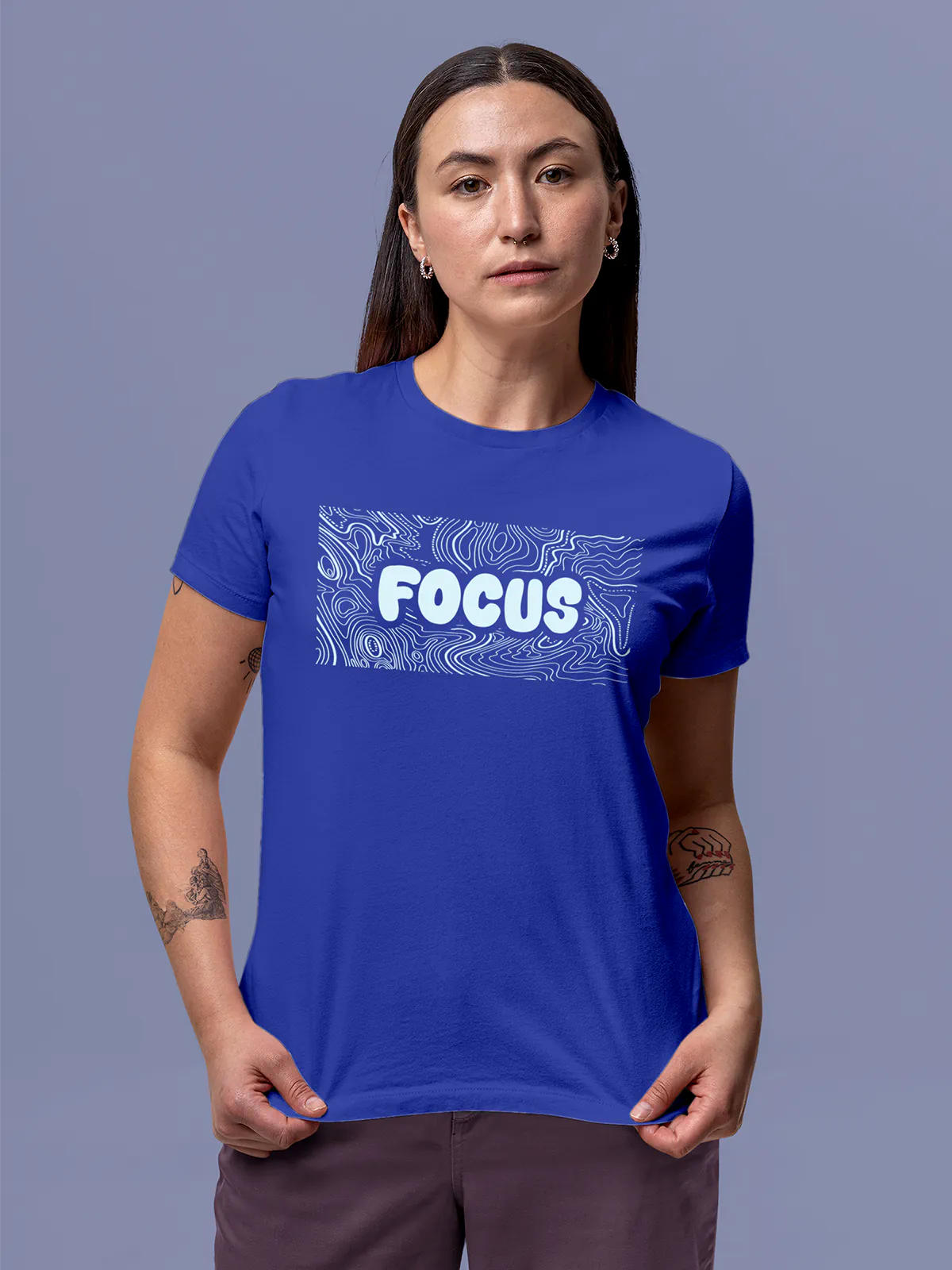 Model wearing Women's Blue Round Neck T-shirt with 'Focus In Chaos' design, offering effortless style and premium comfort