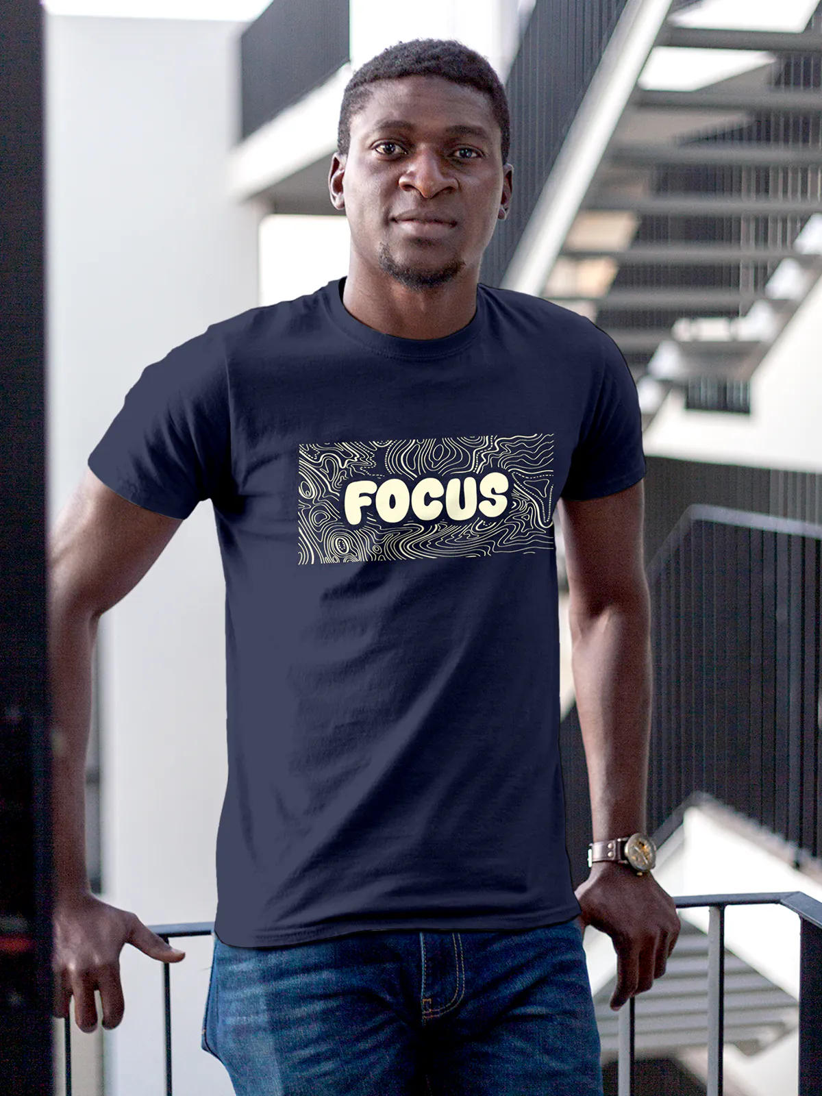Model wearing Men's Navy Blue Round Neck T-shirt with 'Focus In Chaos' design, offering effortless style and premium comfort