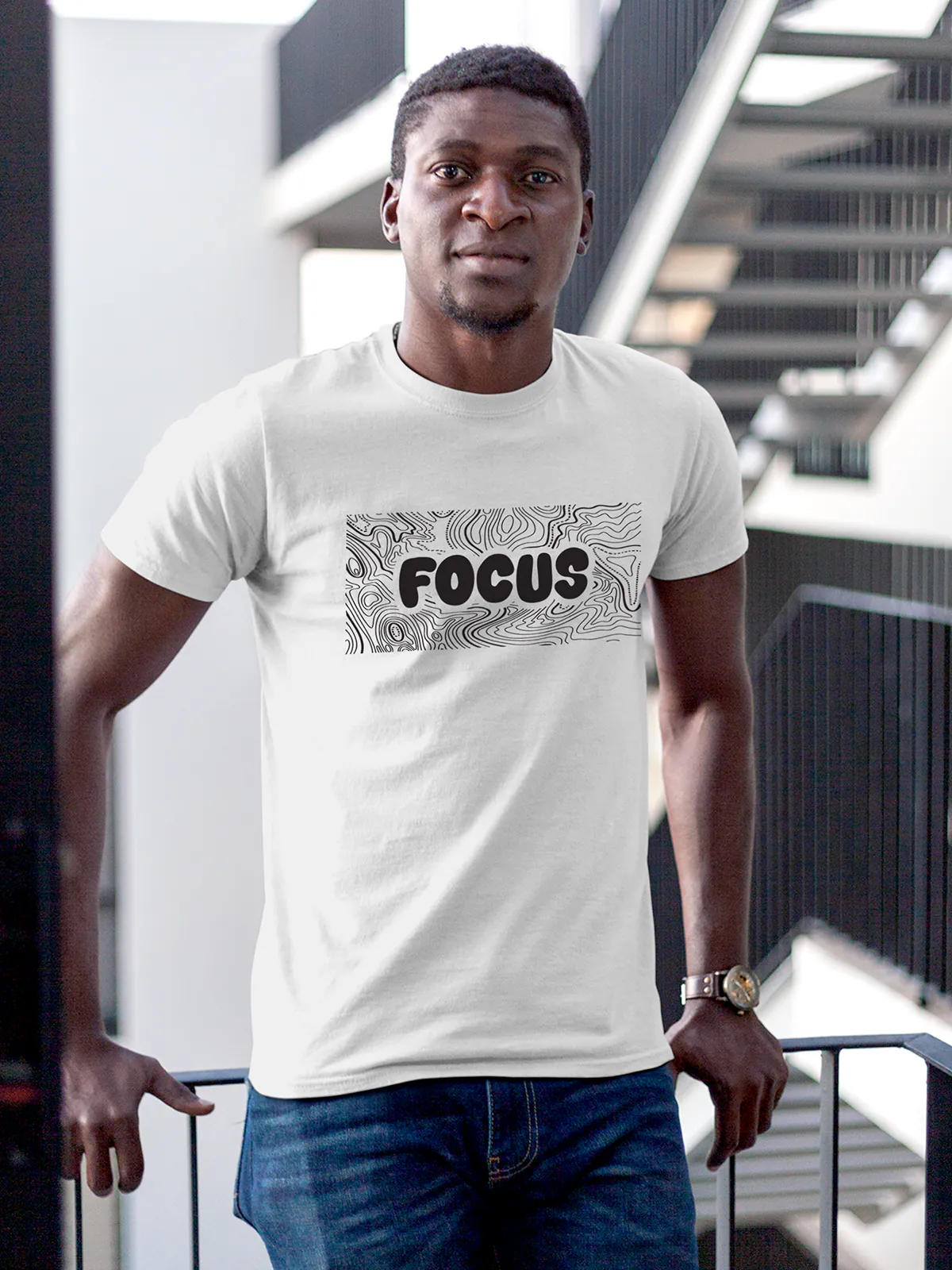 Model wearing Men's White Round Neck T-shirt with 'Focus In Chaos' design, offering effortless style and premium comfort