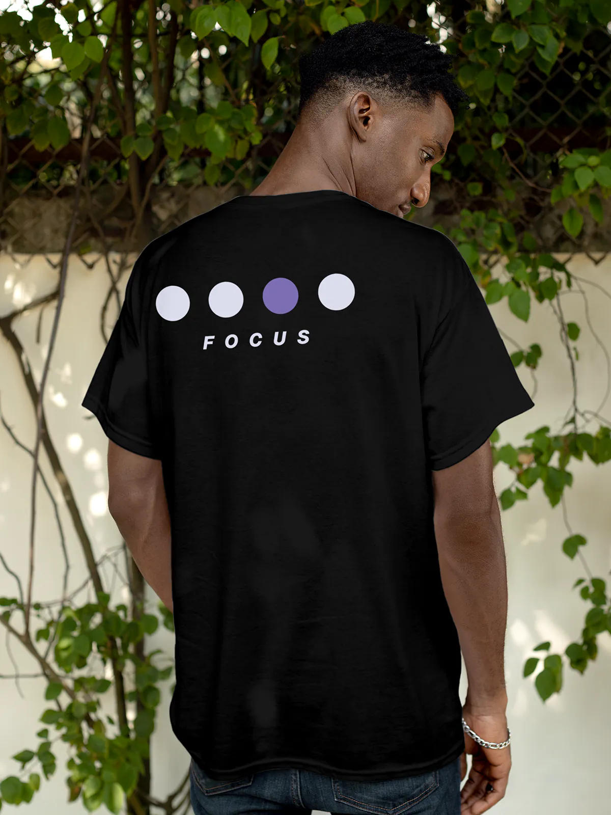 Model wearing Men's Black Round Neck T-shirt with 'Focus On Goal' design, offering effortless style and premium comfort