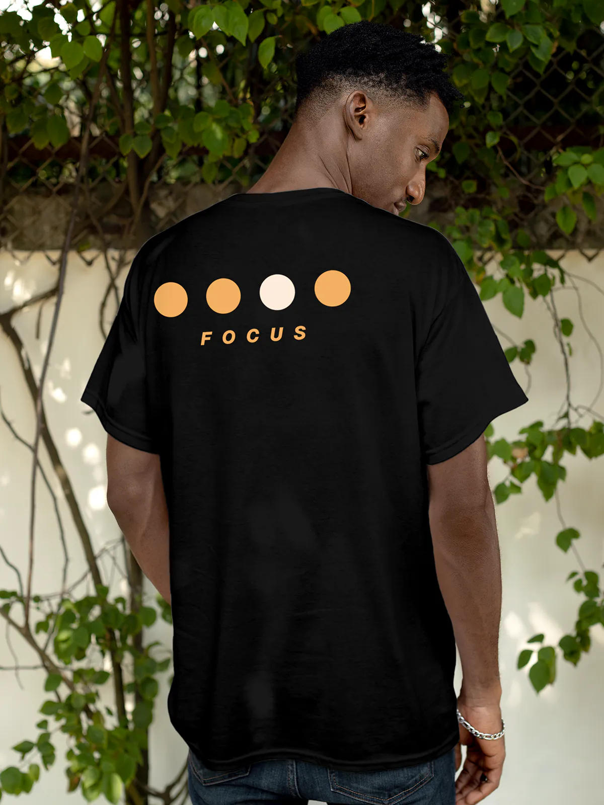 Model wearing Men's Black Round Neck T-shirt with 'Focus On Goal' design, offering effortless style and premium comfort