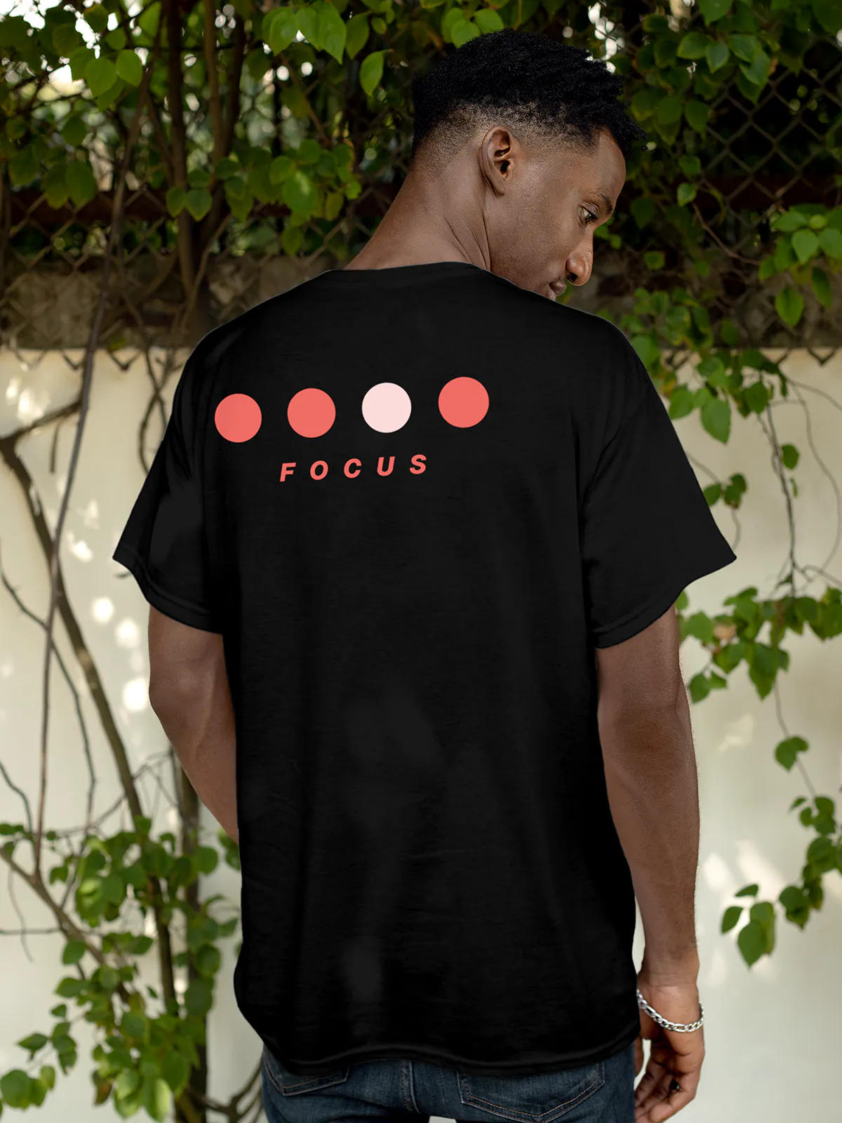 Model wearing Men's Black Round Neck T-shirt with 'Focus On Goal' design, offering effortless style and premium comfort