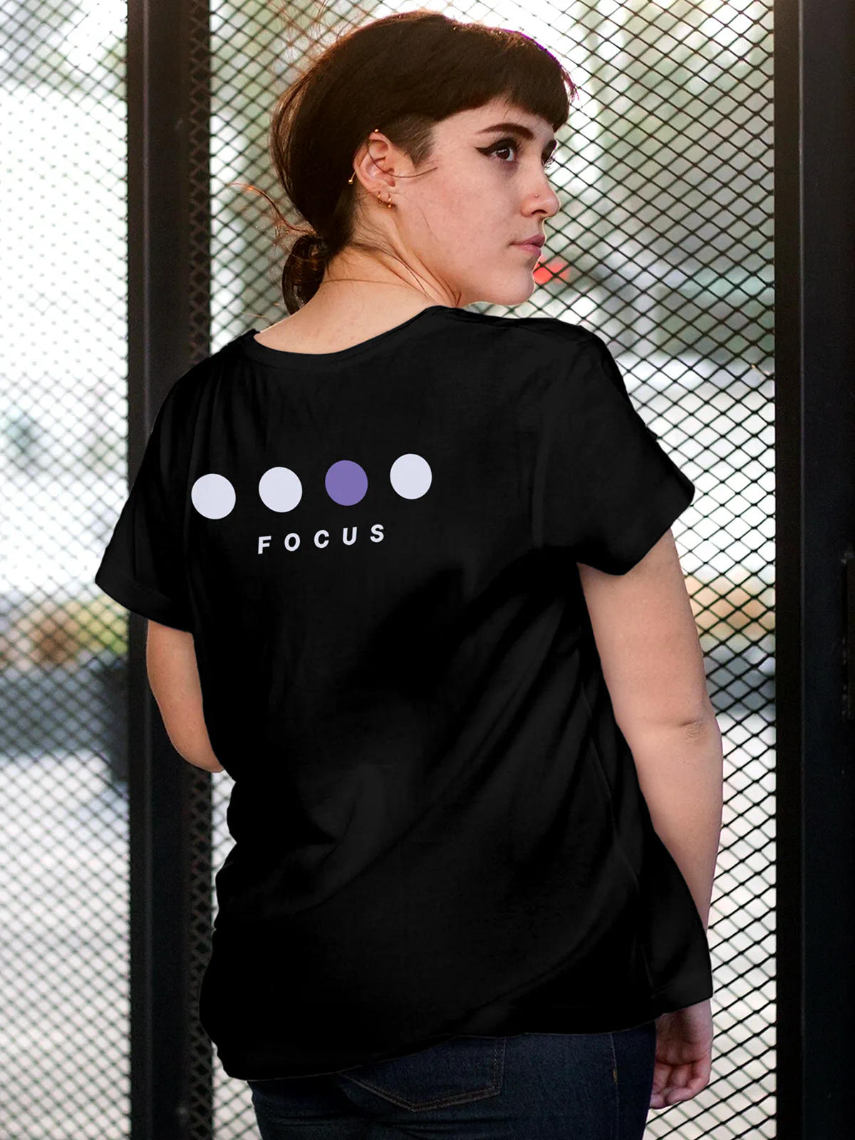 Model wearing Women's Black Round Neck T-shirt with 'Focus On Goal' design, offering effortless style and premium comfort
