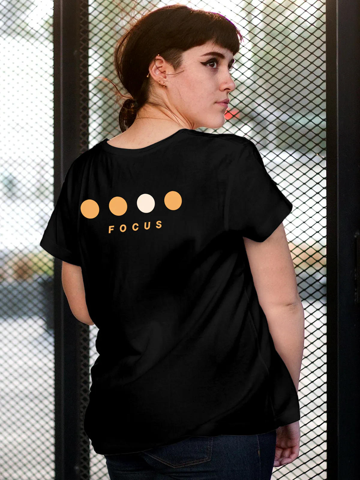 Model wearing Women's Black Round Neck T-shirt with 'Focus On Goal' design, offering effortless style and premium comfort