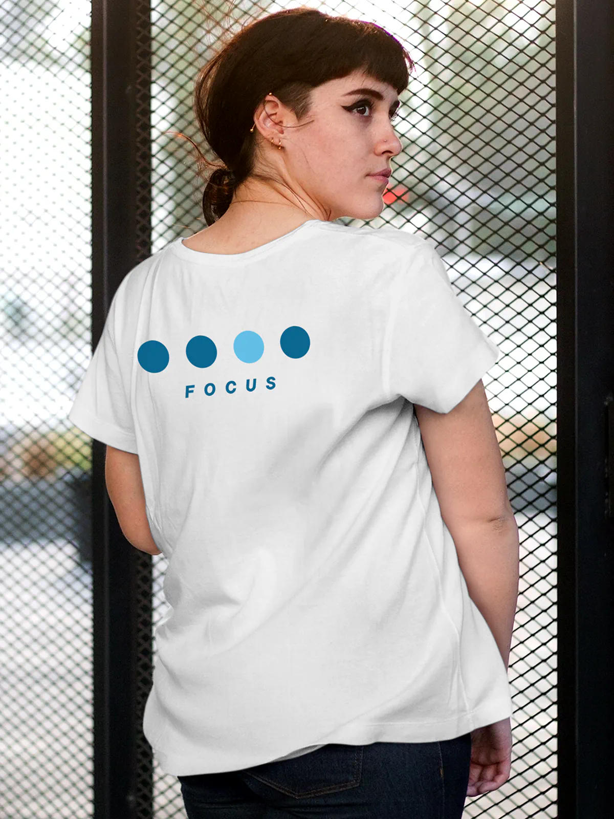 Model wearing Women's White Round Neck T-shirt with 'Focus On Goal' design, offering effortless style and premium comfort