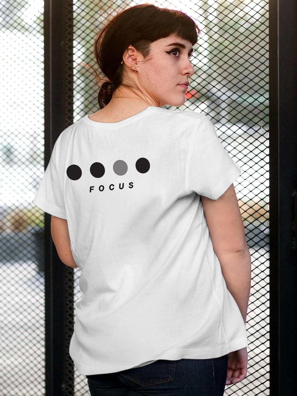 Model wearing Women's White Round Neck T-shirt with 'Focus On Goal' design, offering effortless style and premium comfort