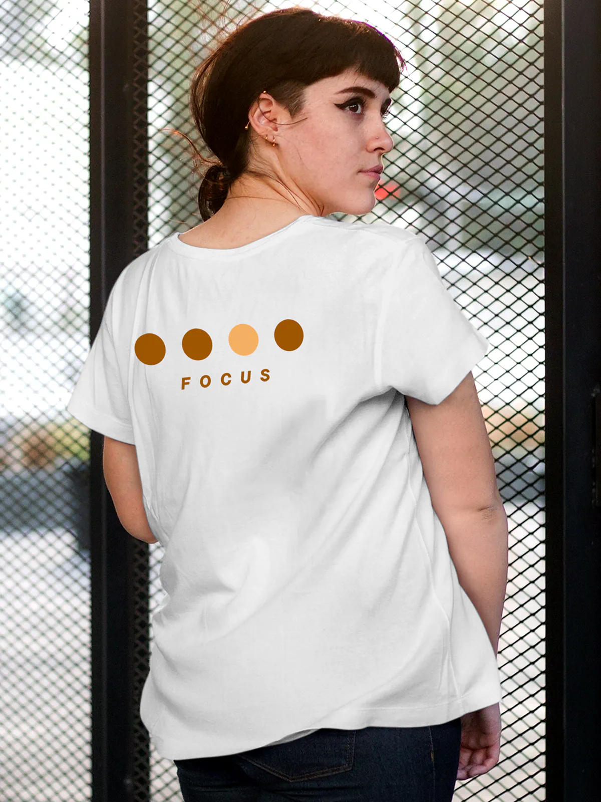 Model wearing Women's White Round Neck T-shirt with 'Focus On Goal' design, offering effortless style and premium comfort