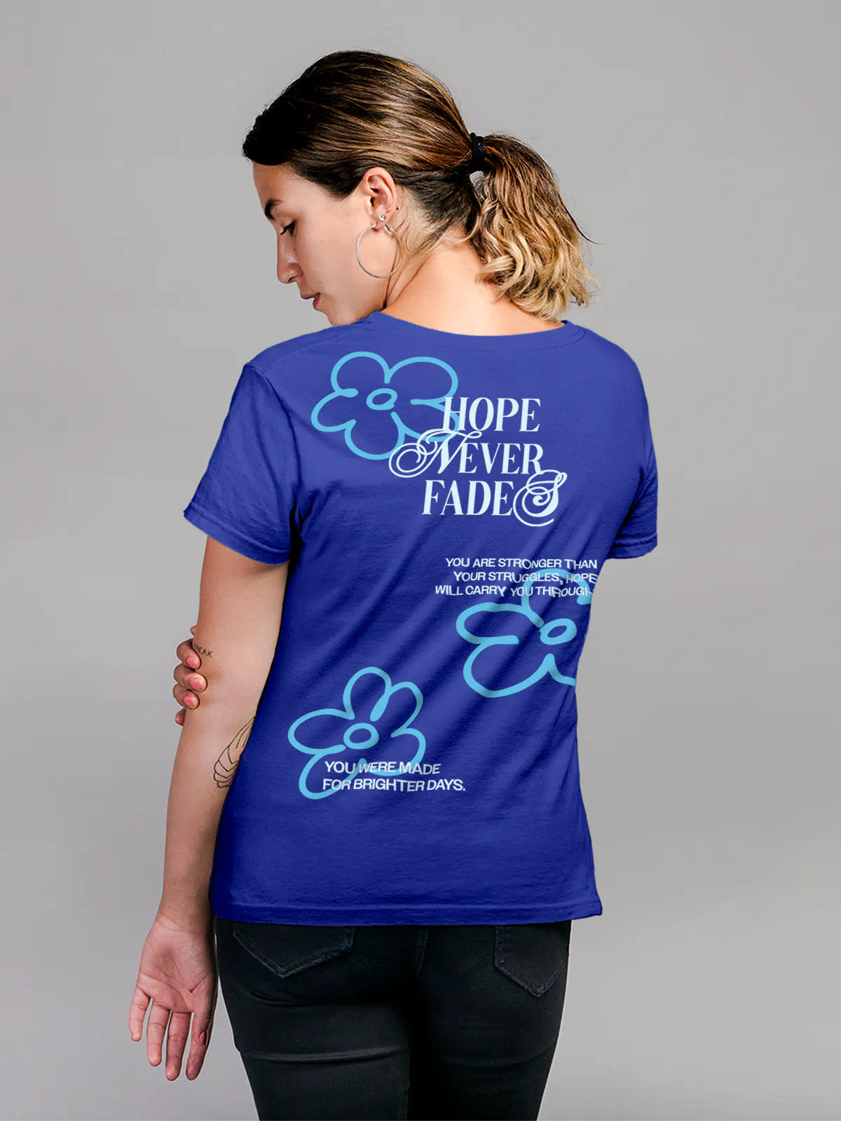 Model wearing Women's Blue Round Neck T-shirt with 'Hope Never Fades' design, offering effortless style and premium comfort