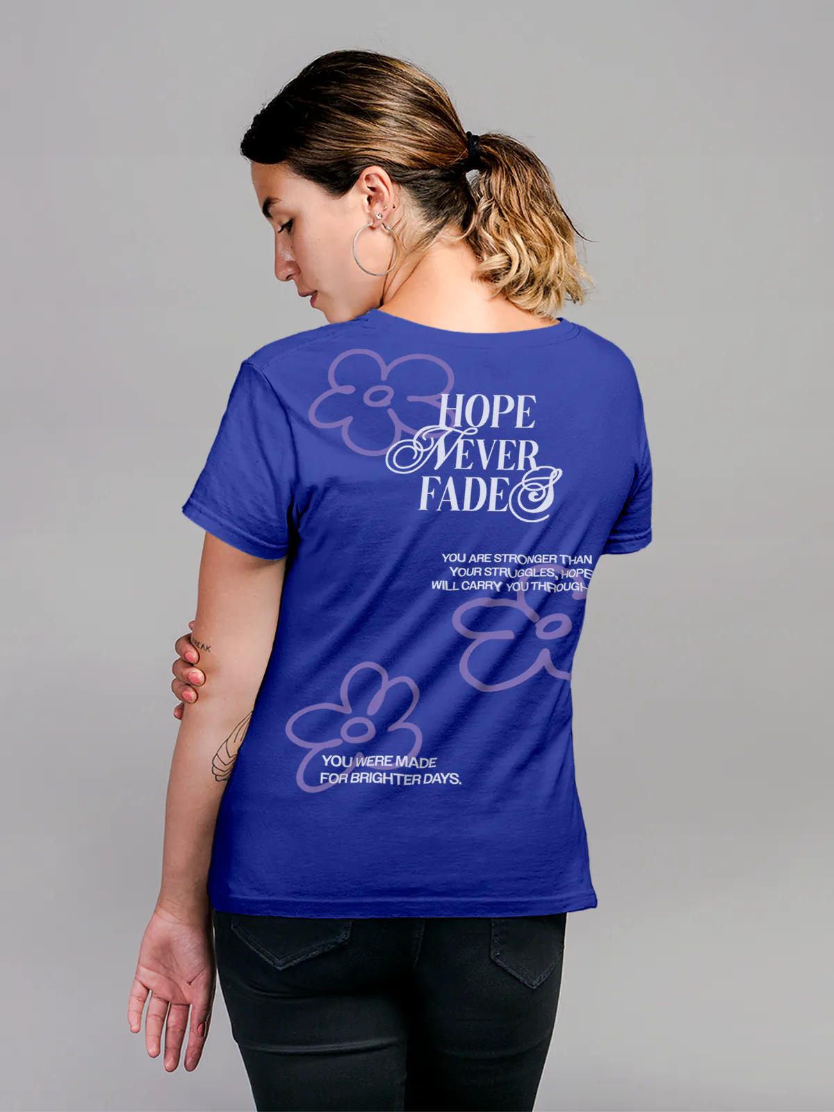 Model wearing Women's Blue Round Neck T-shirt with 'Hope Never Fades' design, offering effortless style and premium comfort
