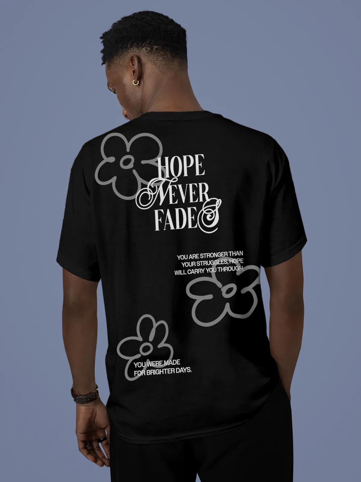 Model wearing Men's Black Round Neck T-shirt with 'Hope Never Fades' design, offering effortless style and premium comfort